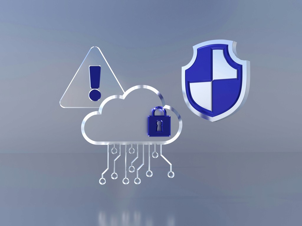 A digital illustration featuring a cloud icon with a padlock, a shield symbol, and an exclamation mark warning sign. The image represents cloud security, data protection, and the importance of cybersecurity measures in safeguarding information and systems against potential threats.