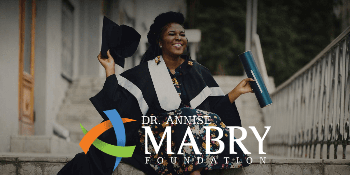 Dr. Annise Mabry celebrates graduation, symbolizing resilience and leadership, reflecting her mission to help CEOs overcome burnout.