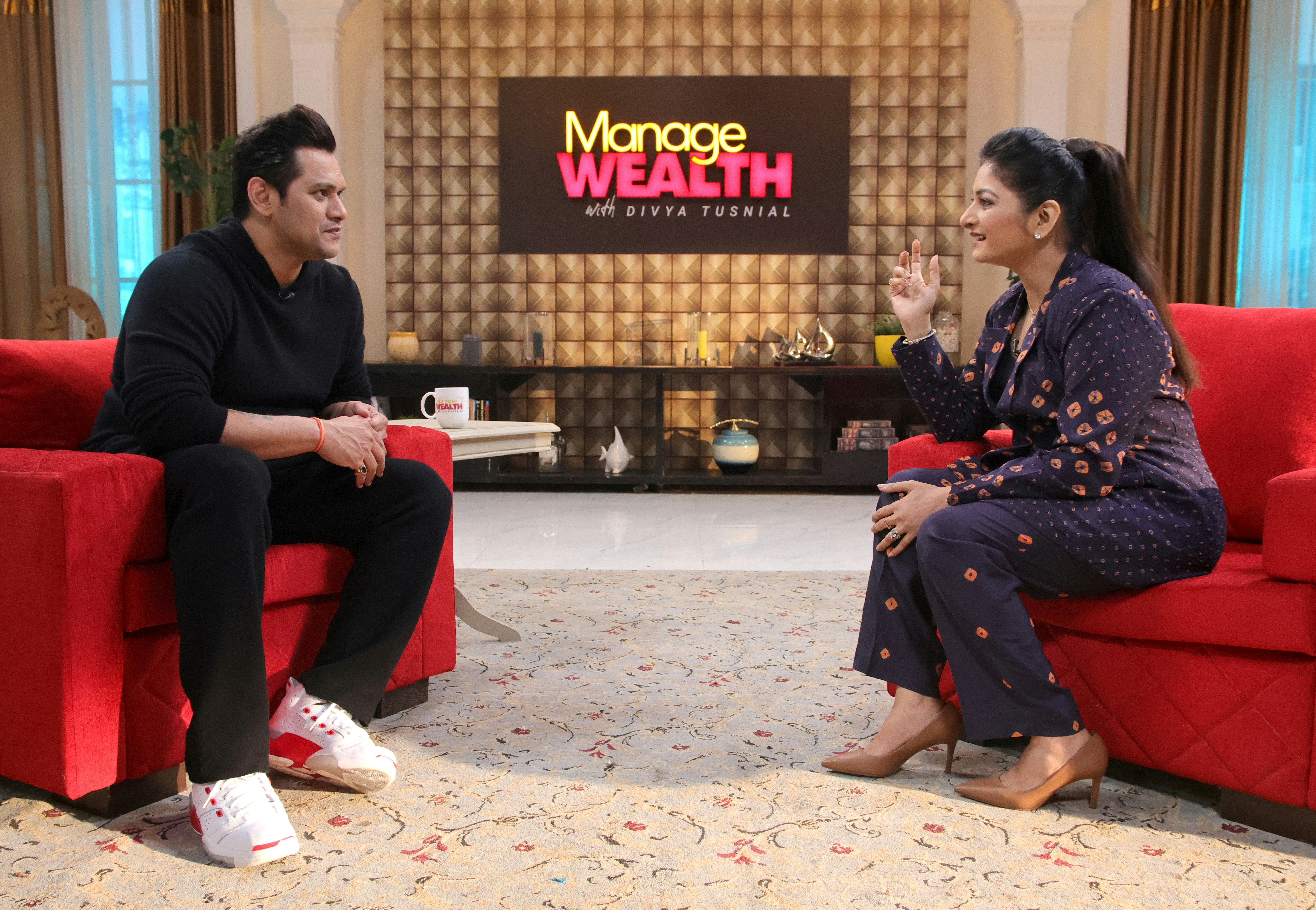 a man and a woman sitting on a red couch