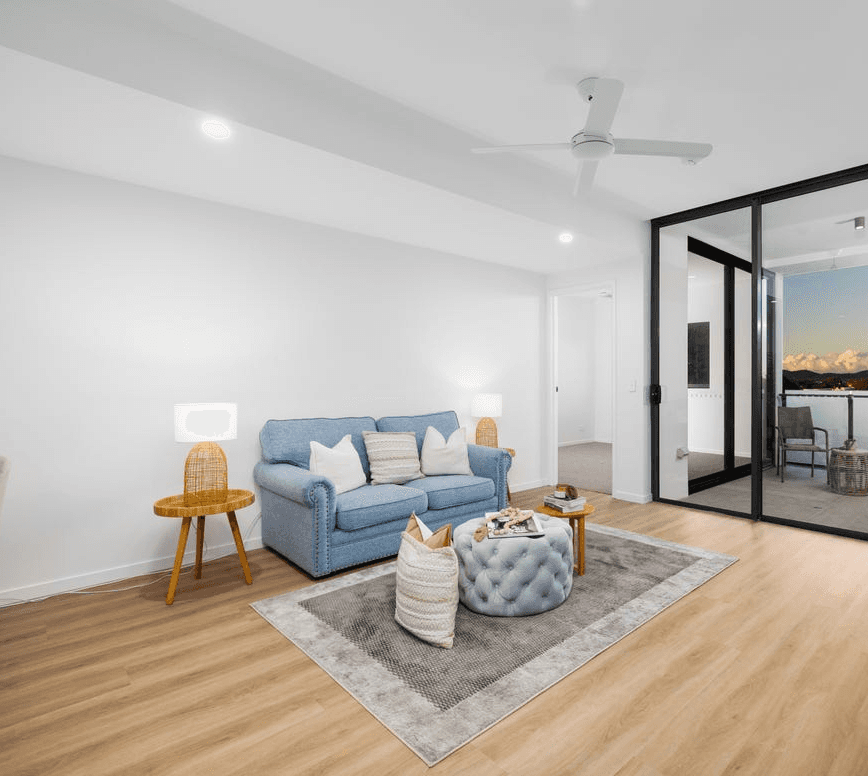 Bright Queensland apartment living room with timber-look hybrid flooring, designed for everyday life with water-resistant surfaces and slip-resistant comfort.