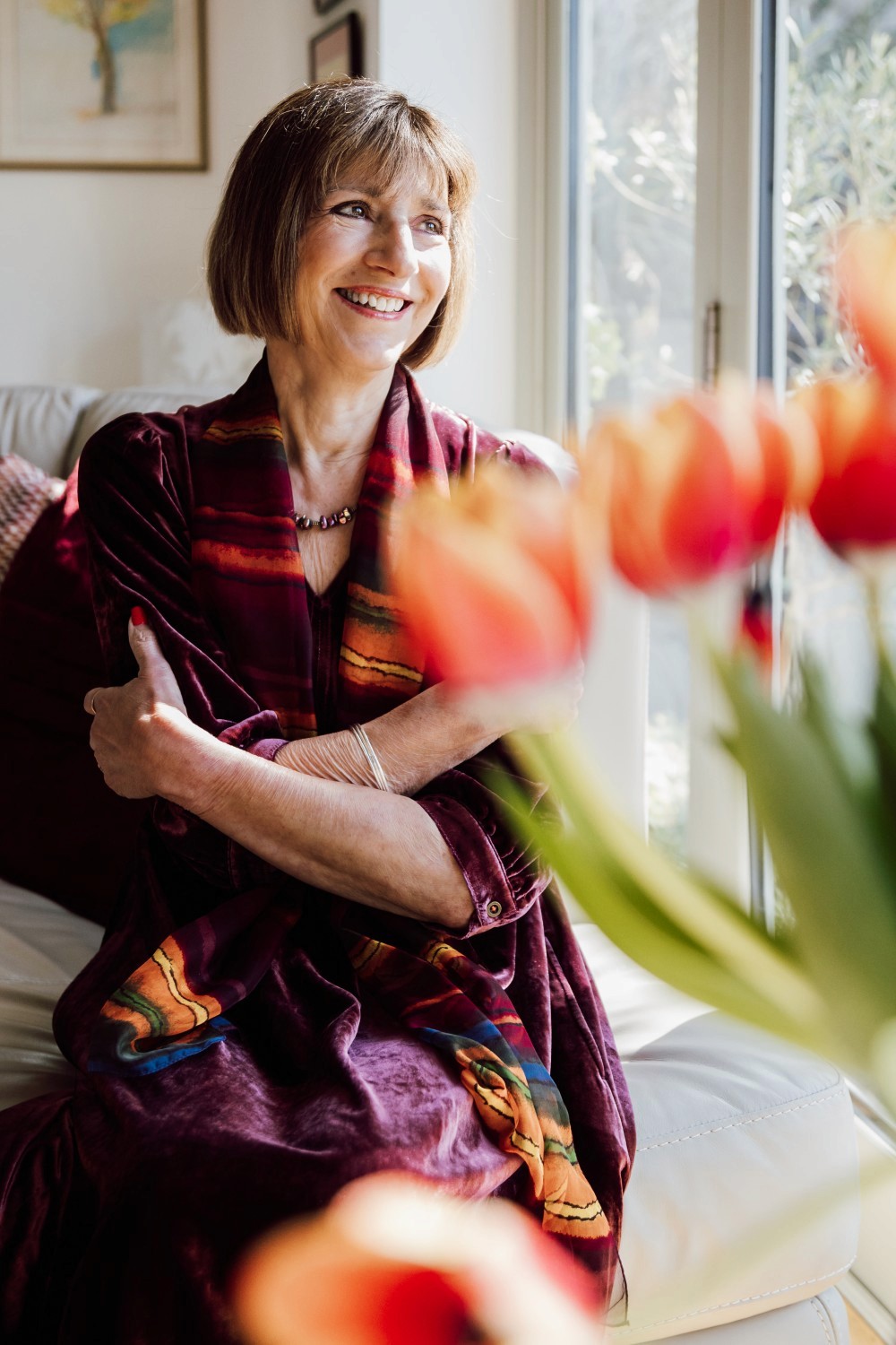 Izzy, smiling lady with vase of tulips