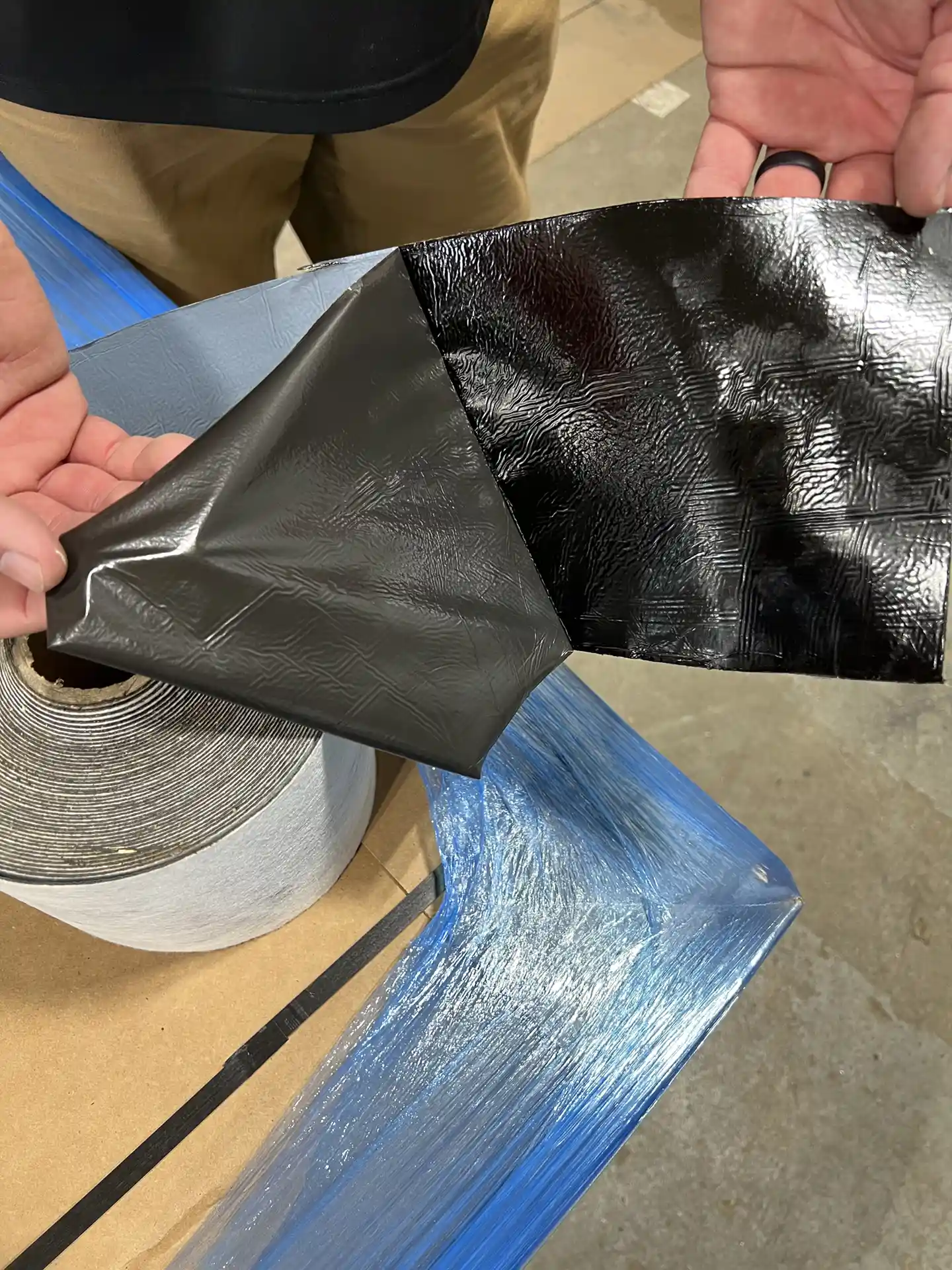 A close-up photo of the self-adhered tape backing to Rub-R-Flash