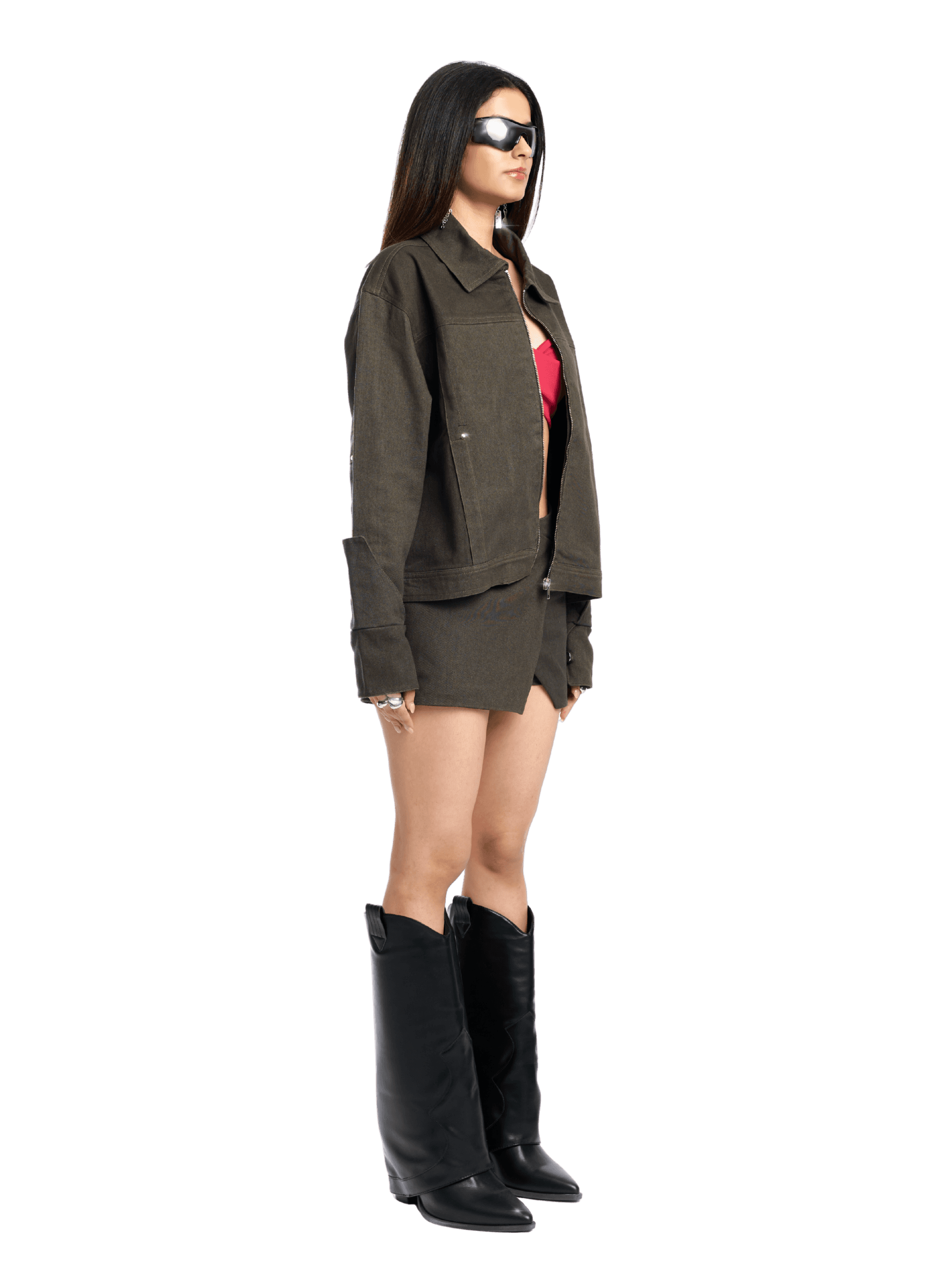 Woman wearing a green jacket and black boots on a white background