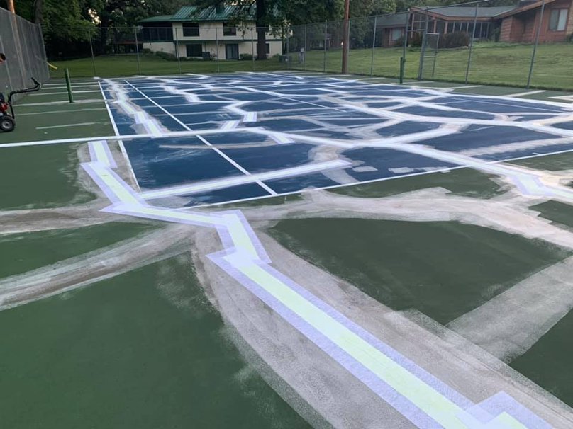 tennis court surface with extensive crack repair preparation before resurfacing