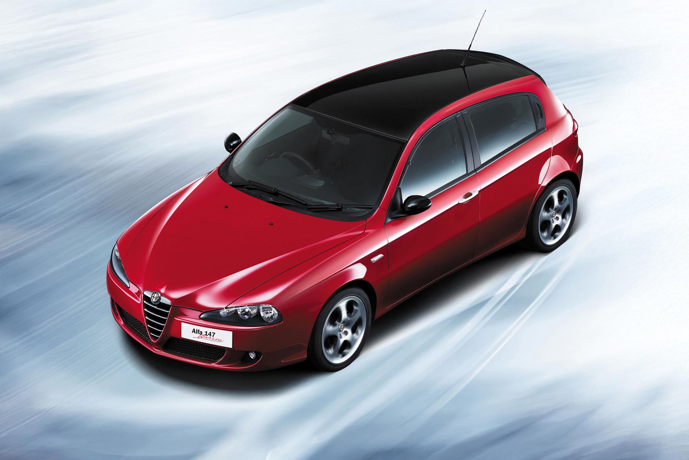 Alfa Romeo 147 press photograph in red, 3/4 front view