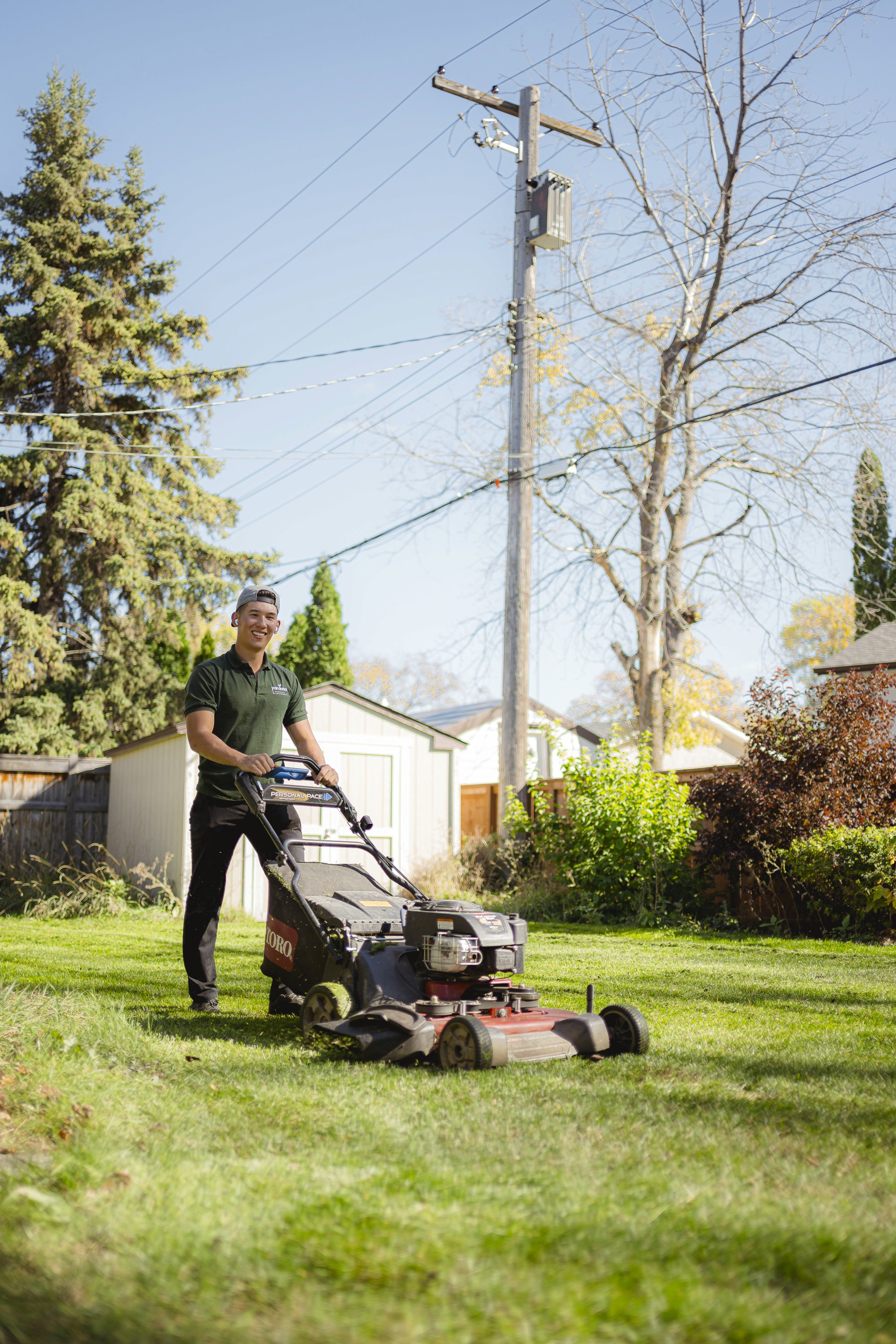 Smiling while mowing the lawn
