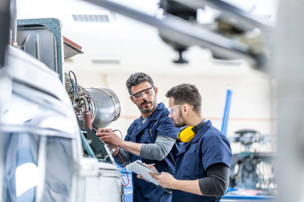 image of two people working on assembling a plane part