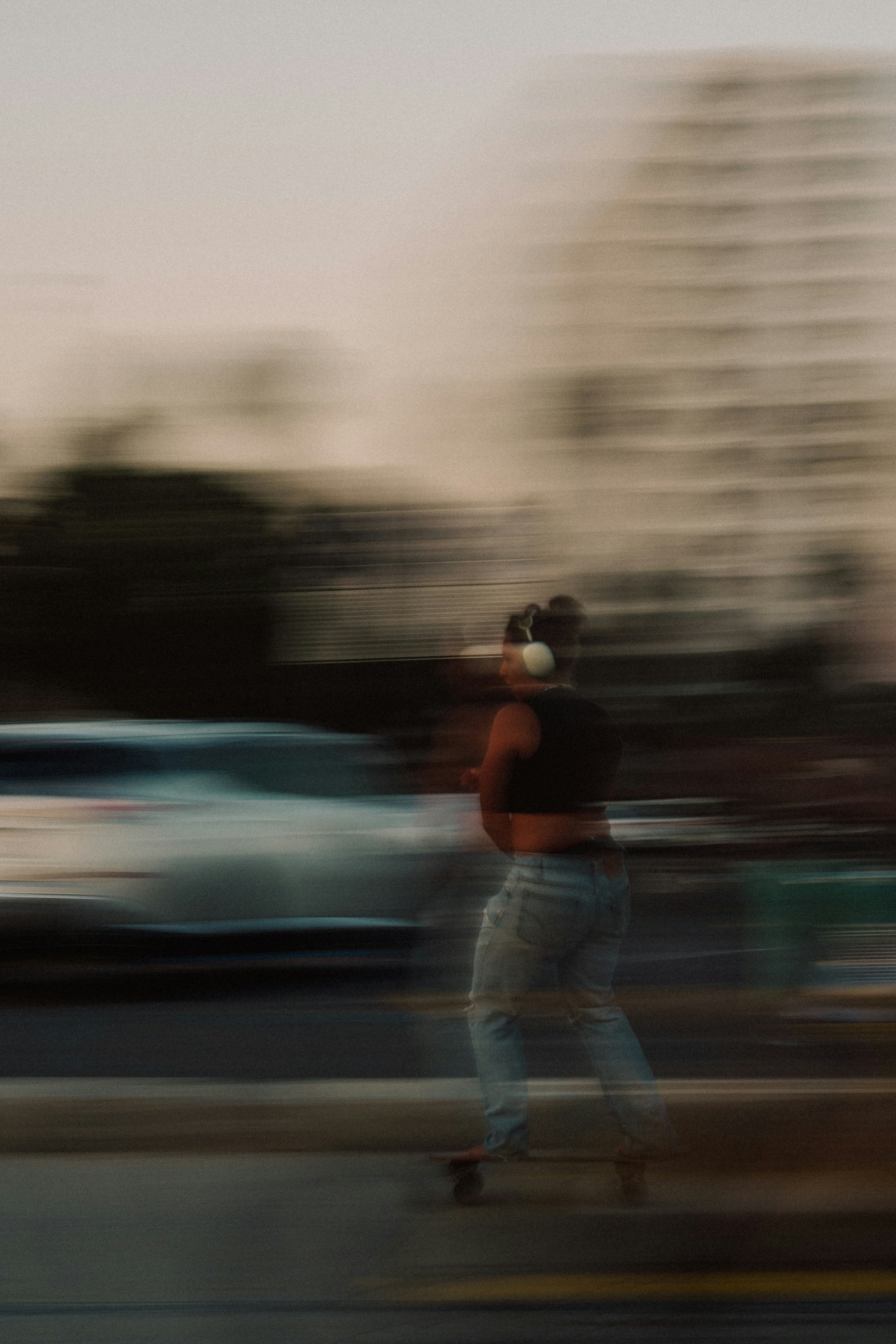 A surreal image of a person in motion, holding flowers in a field with a futuristic circular structure in the background.