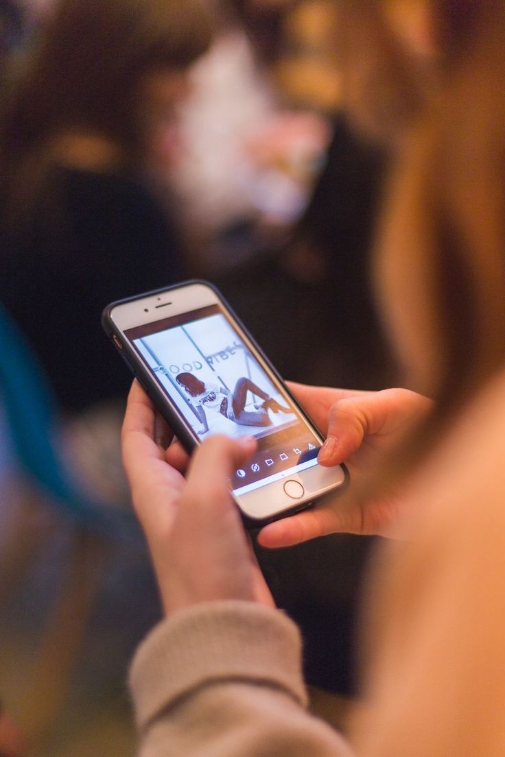 A person holding a cell phone in their hand