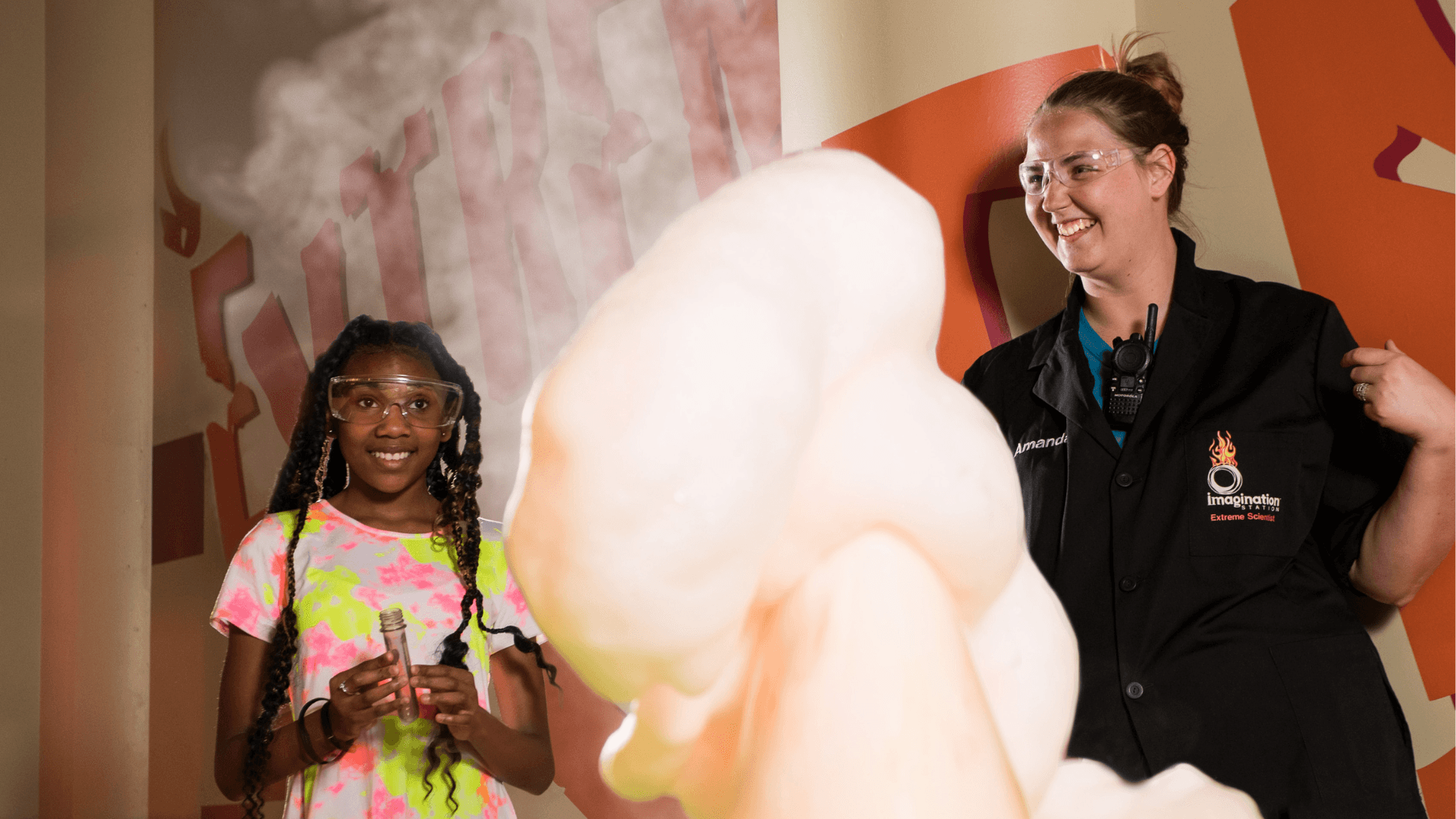 An Extreme Scientist shows a young girl an Elephant's Toothpaste explosion.