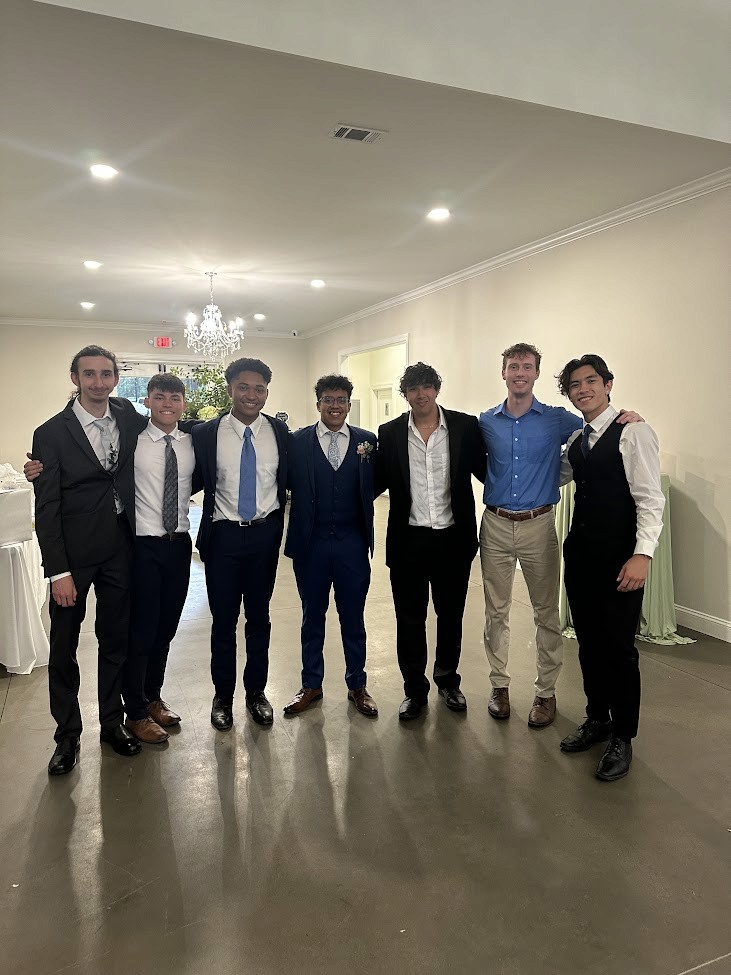 Two women reviewing fashion sketches and a large design document.