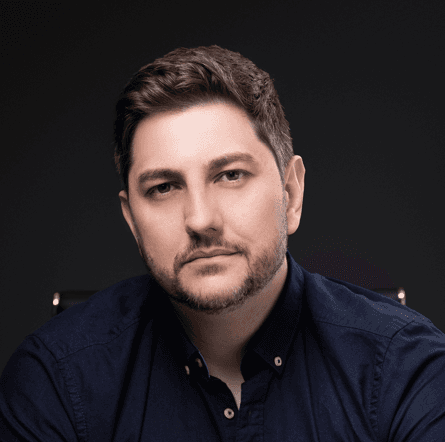Profile portrait of a man in a grey shirt