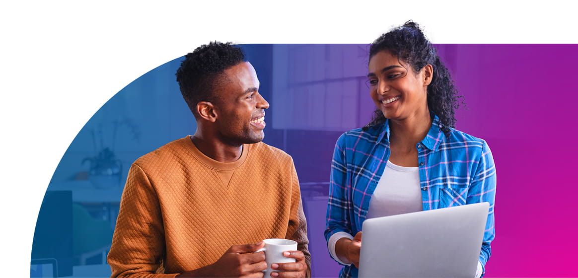 Two designers colloborating in front of a laptop