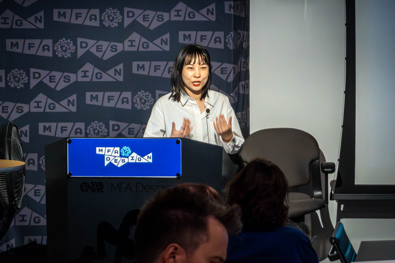 Woman at a podium delivering a presentation