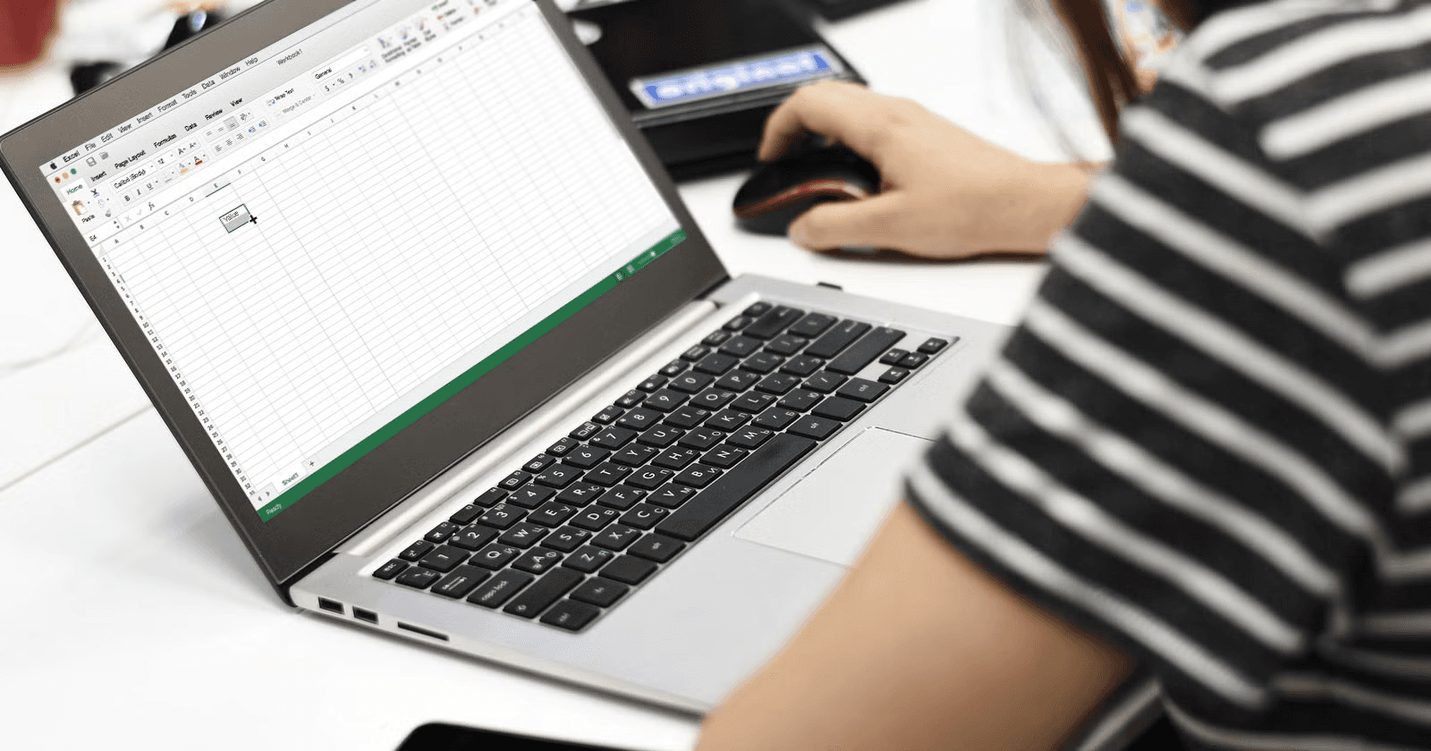Person works on an Excel spreadsheet - How to Categorize Data Into Groups in Excel