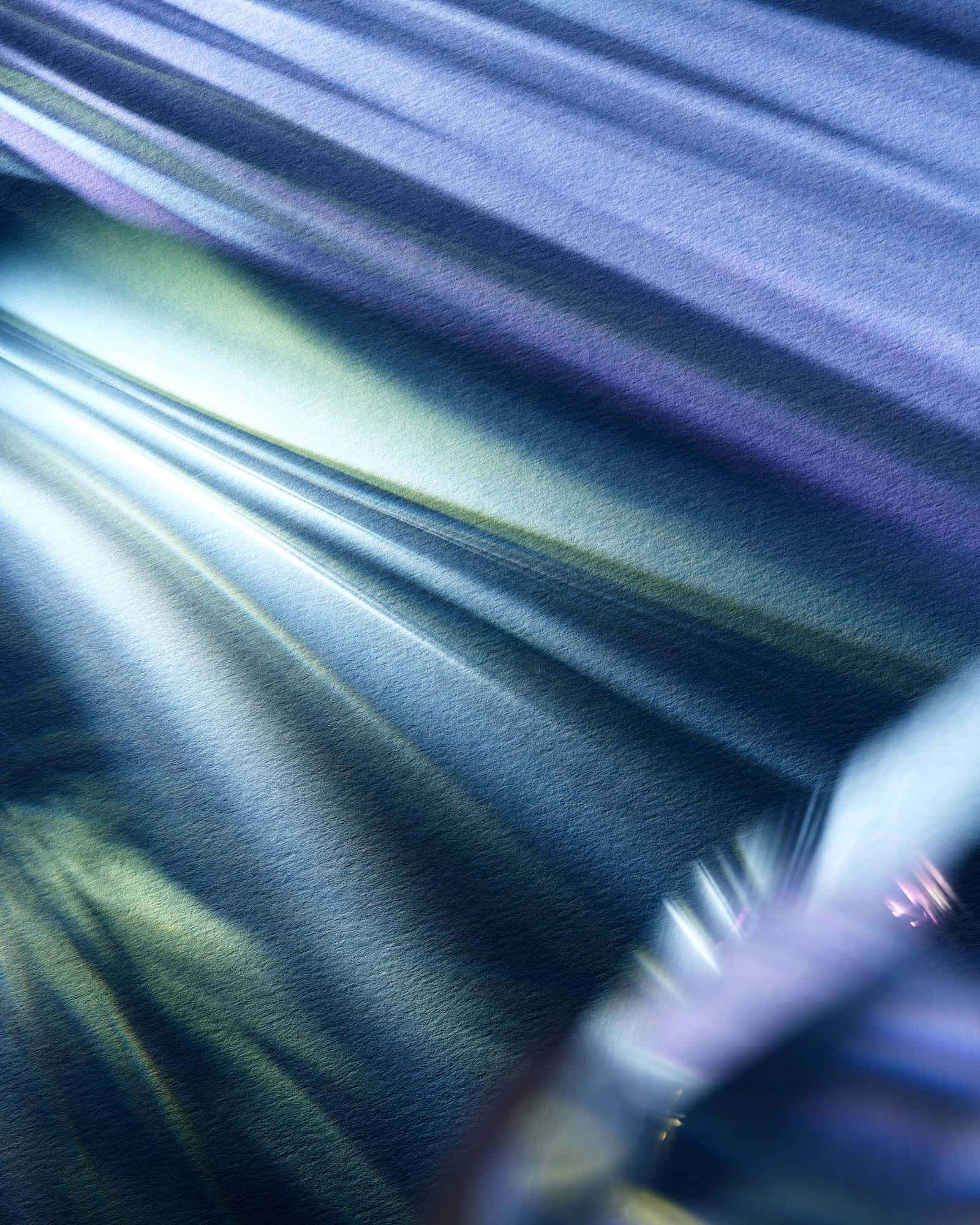 Abstract blue and green light patterns with texture and gradient effects.