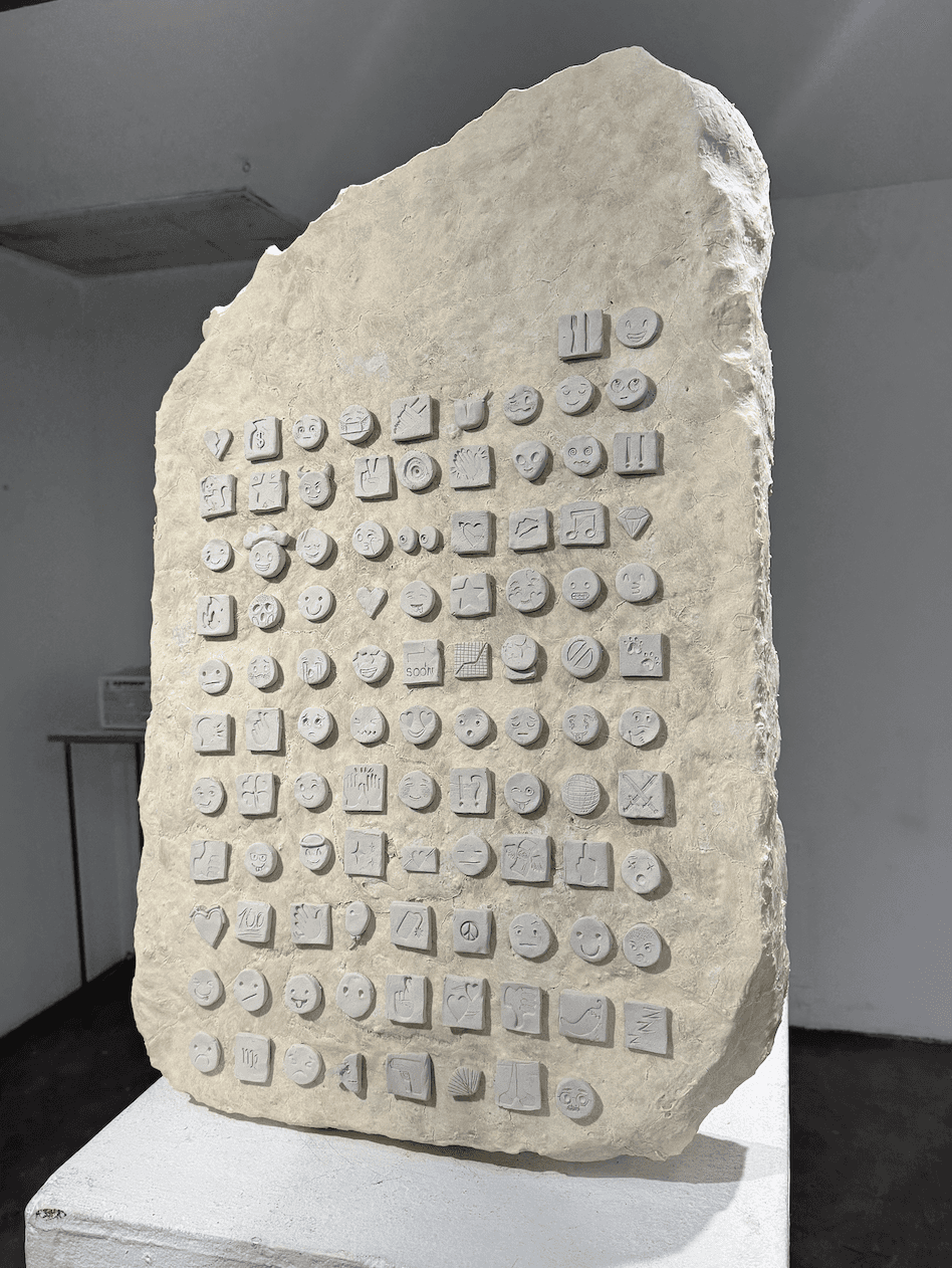 Bright orange textured cap balanced on fingertips against a vivid blue sky with scattered clouds.