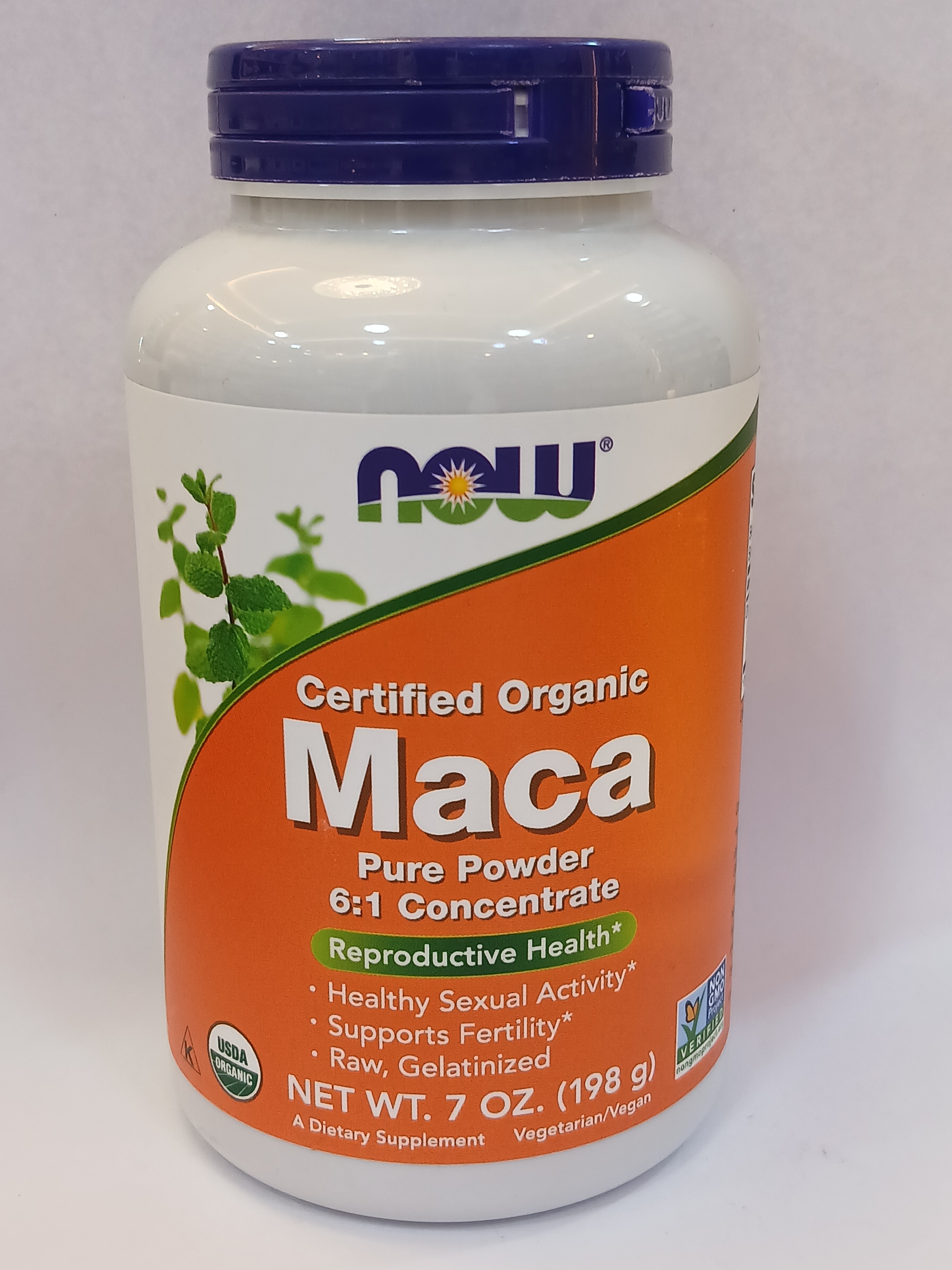 A white plastic bottle with a purple cap and orange label displaying green leaf graphics sits against a plain white background.