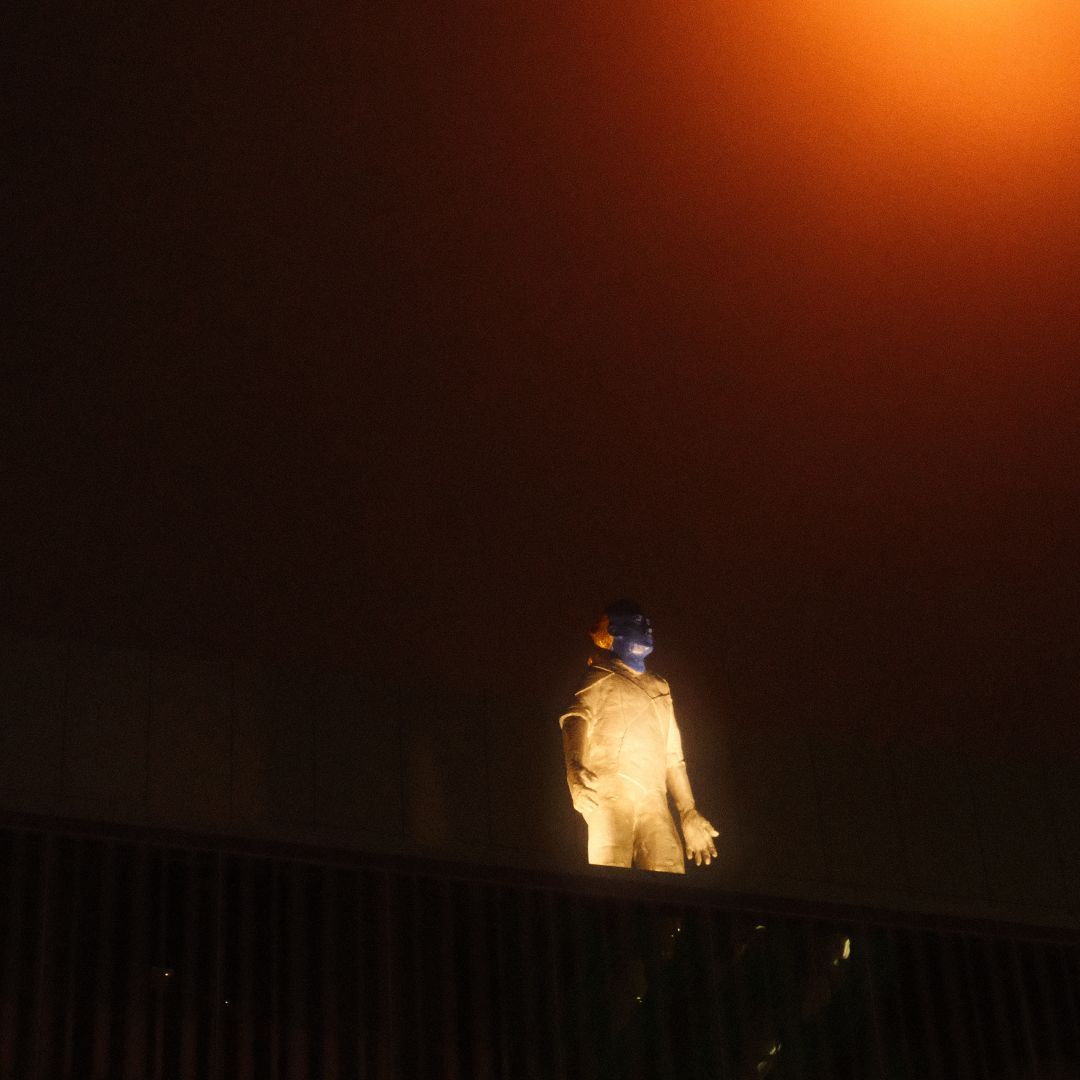 a group of people walking on a sidewalk