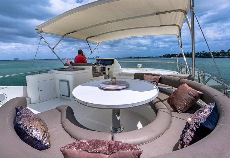 Spacious flybridge on the Ferretti Lumar 75ft yacht with seating and a BBQ area.