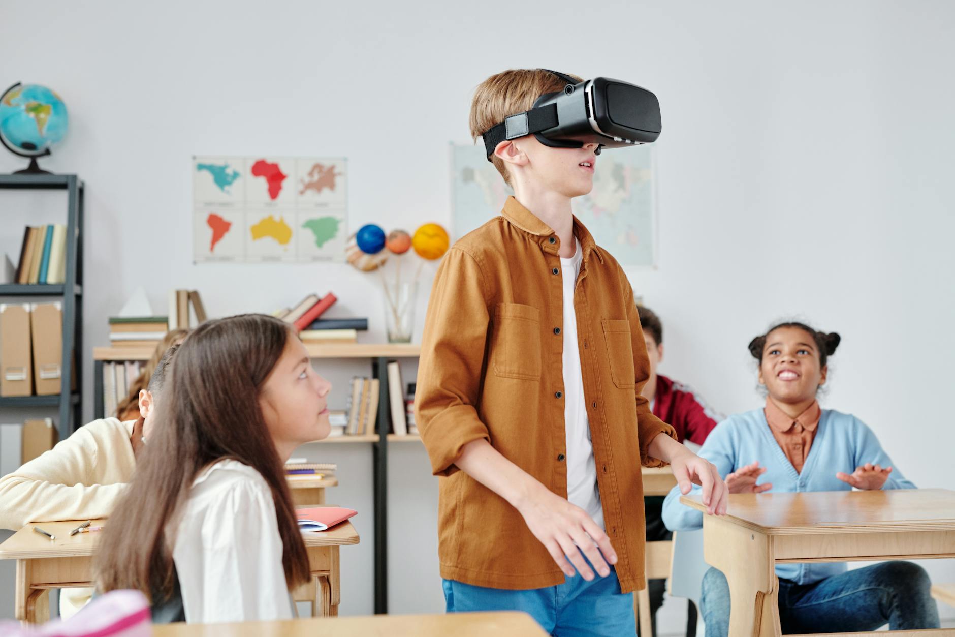 A young student wearing a VR headset while exploring a futuristic virtual laboratory using games for classroom online.