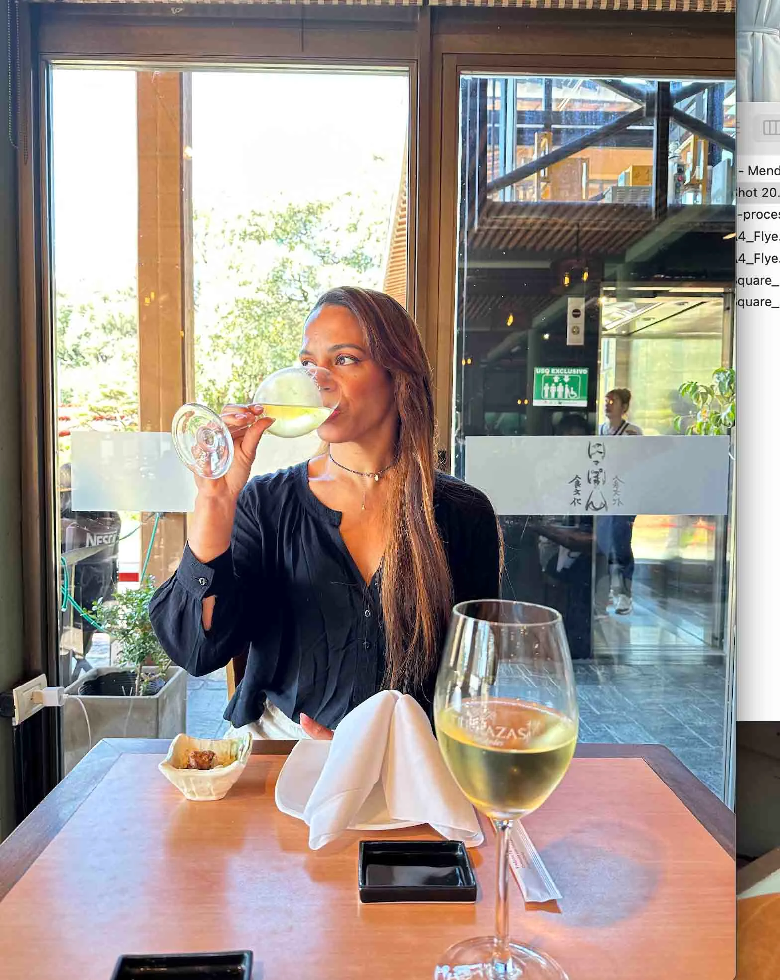 Yoania drinking a glass of wine