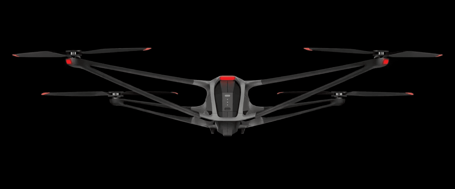 Modern drone with black propellers and a red accent on the front. Aerial technology. Close-up view.