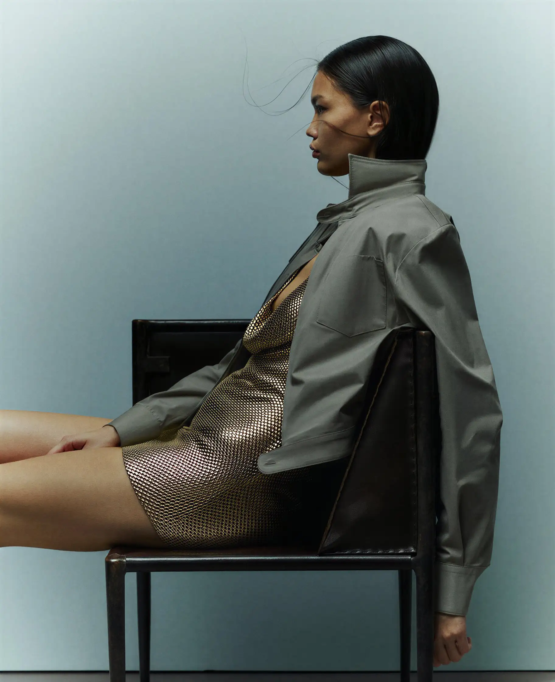 Torii gate silhouetted against a sunset over a city.