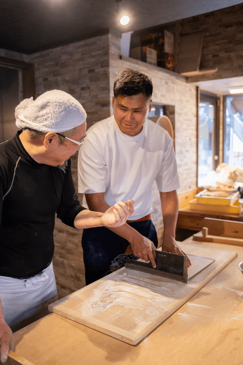 Soba chef teaching how to cut soba noodles
