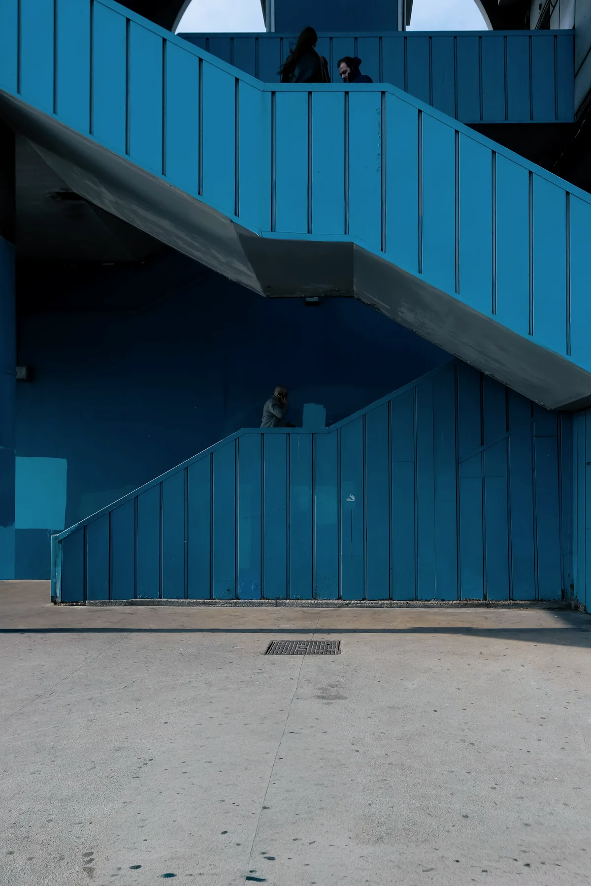 Blue painted concrete stairs climbing a facade