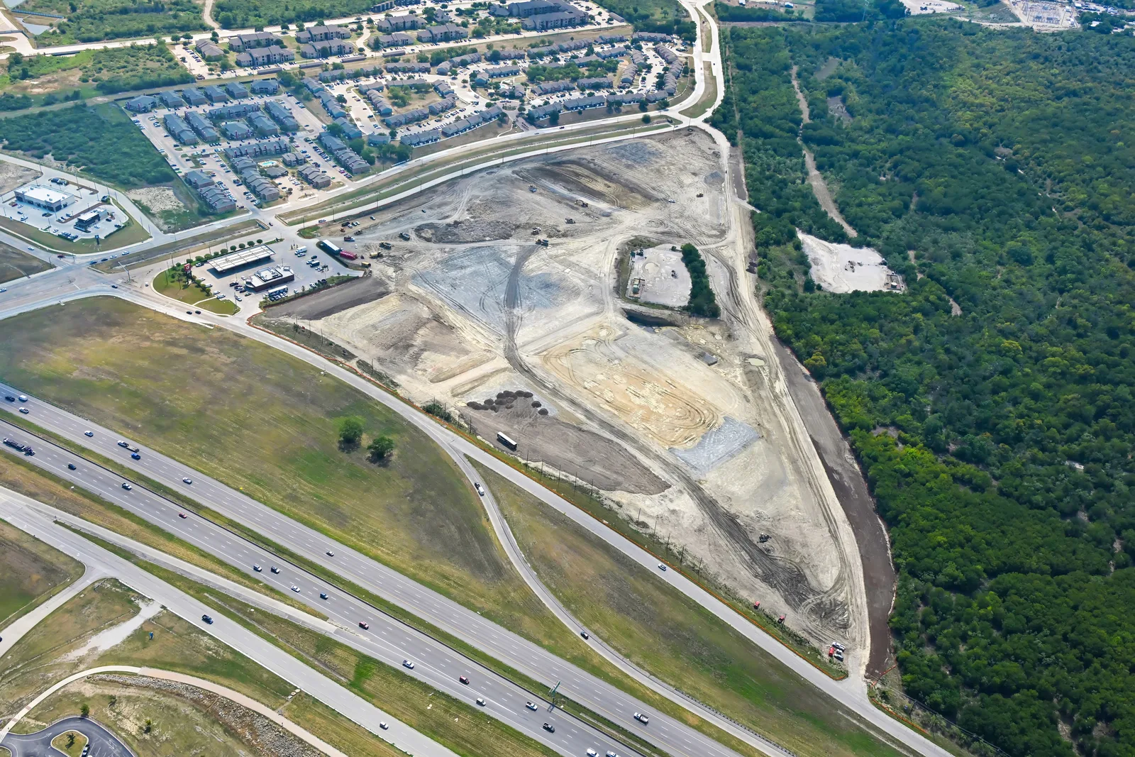 Aerial view of site grading underway at MC820 Logistics beside the highway interchange