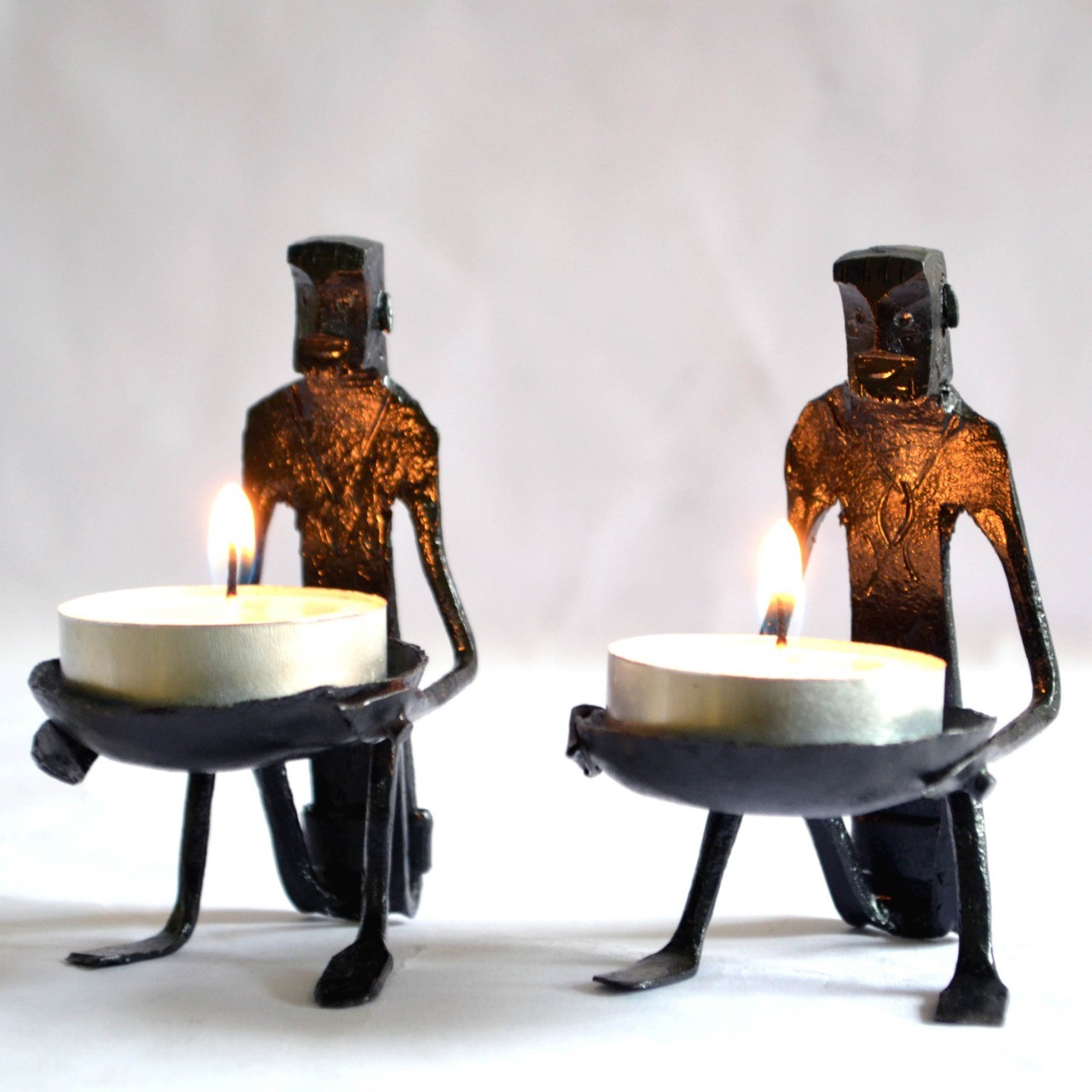 Handcrafted tribal metal figurine tea light candle holders set of two