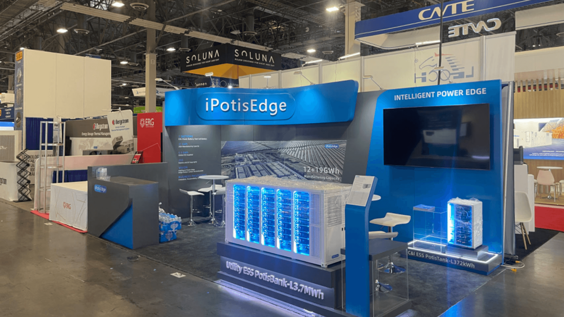 IpstisEdge RE+ 2023 10x20 energy storage booth in Las Vegas with illuminated Utility ESS PotisBank display, monitor wall, and technical graphics