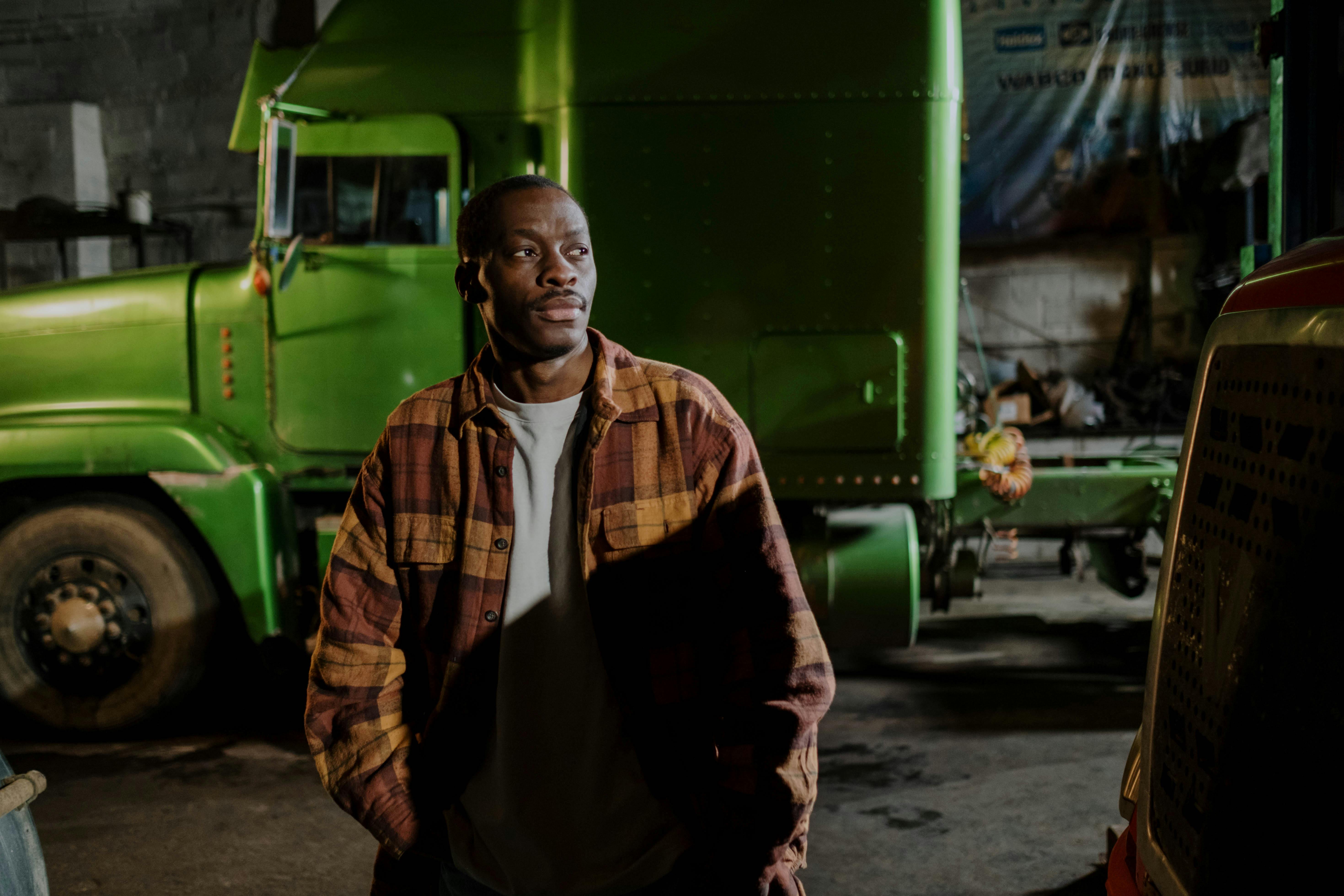 Mechanic walking infront of a green truck