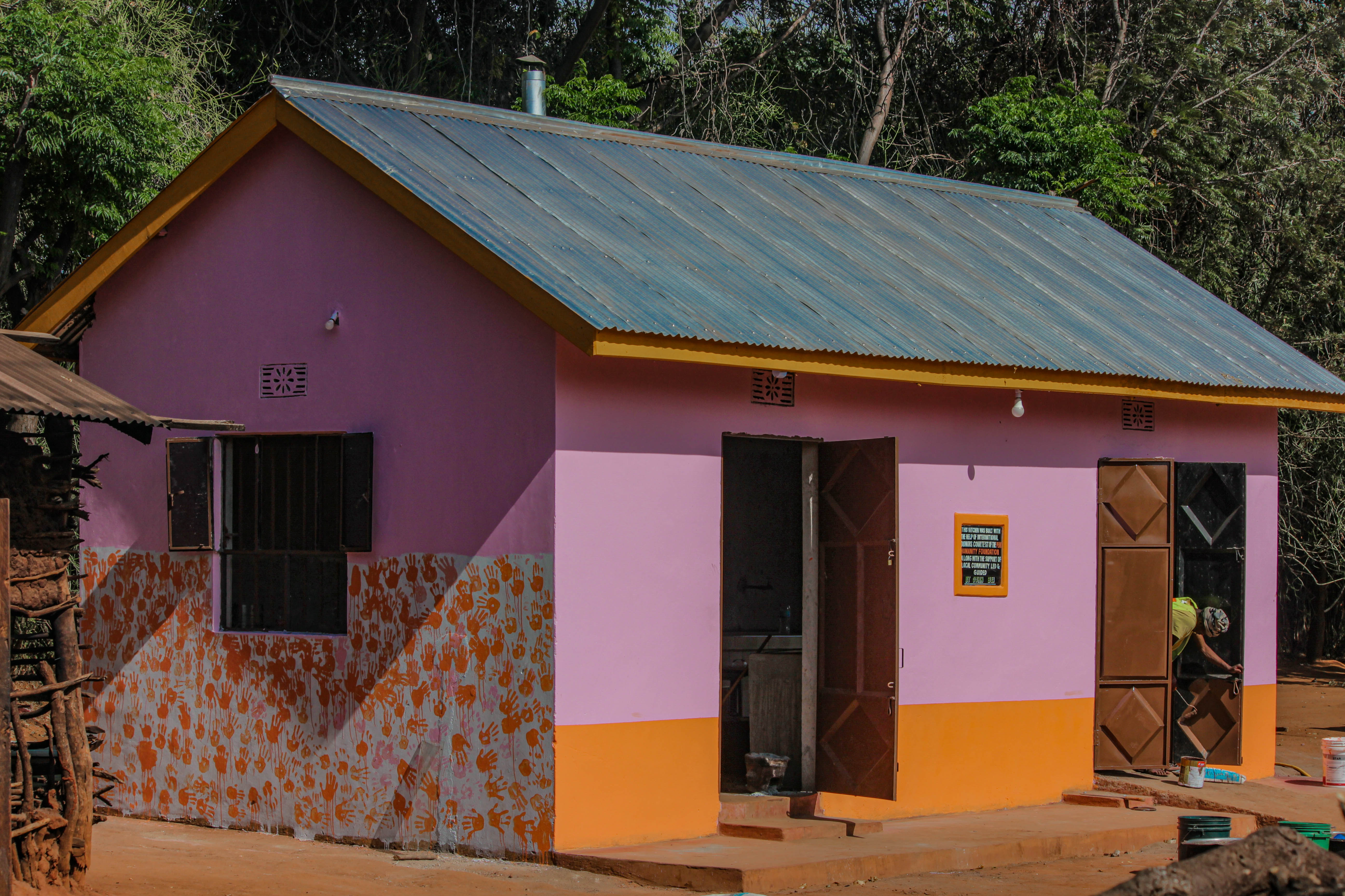 A bright shot of the new purple kitchen with children’s handprints on the wall.