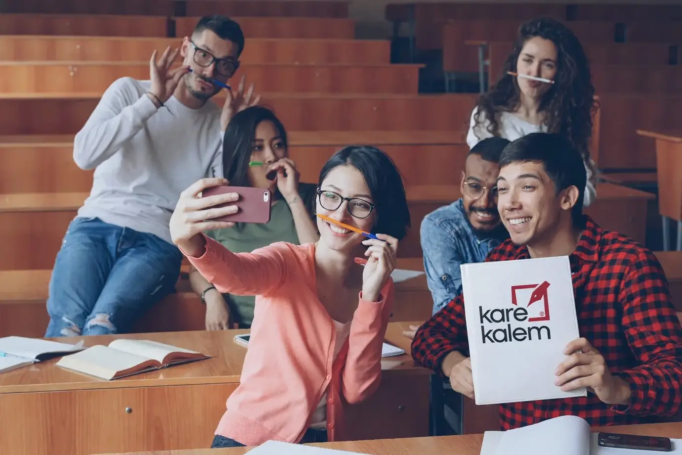 Students taking a selfie in a lecture hall.