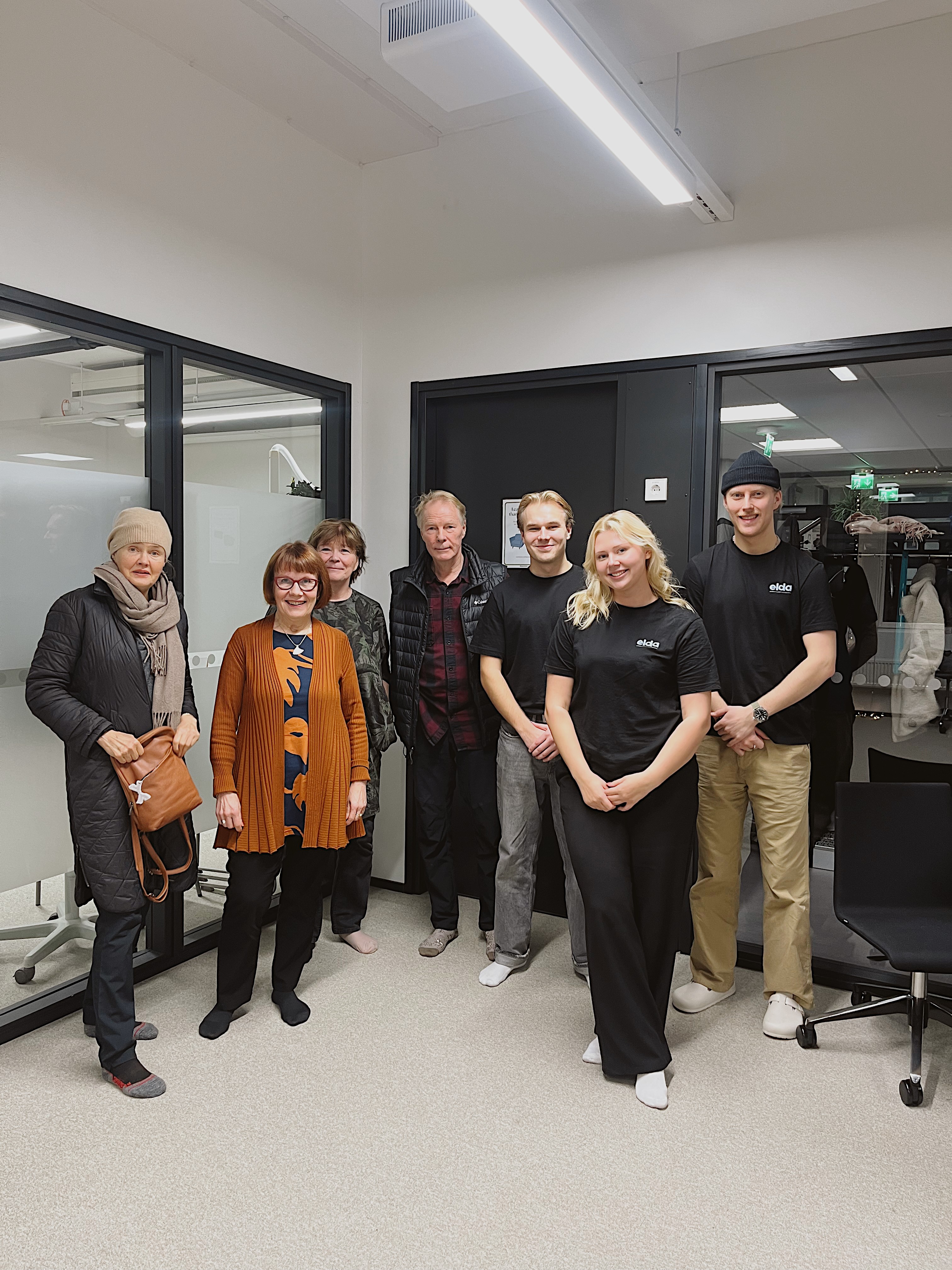 woman holding a phone and man looking at the phone. both are smiling