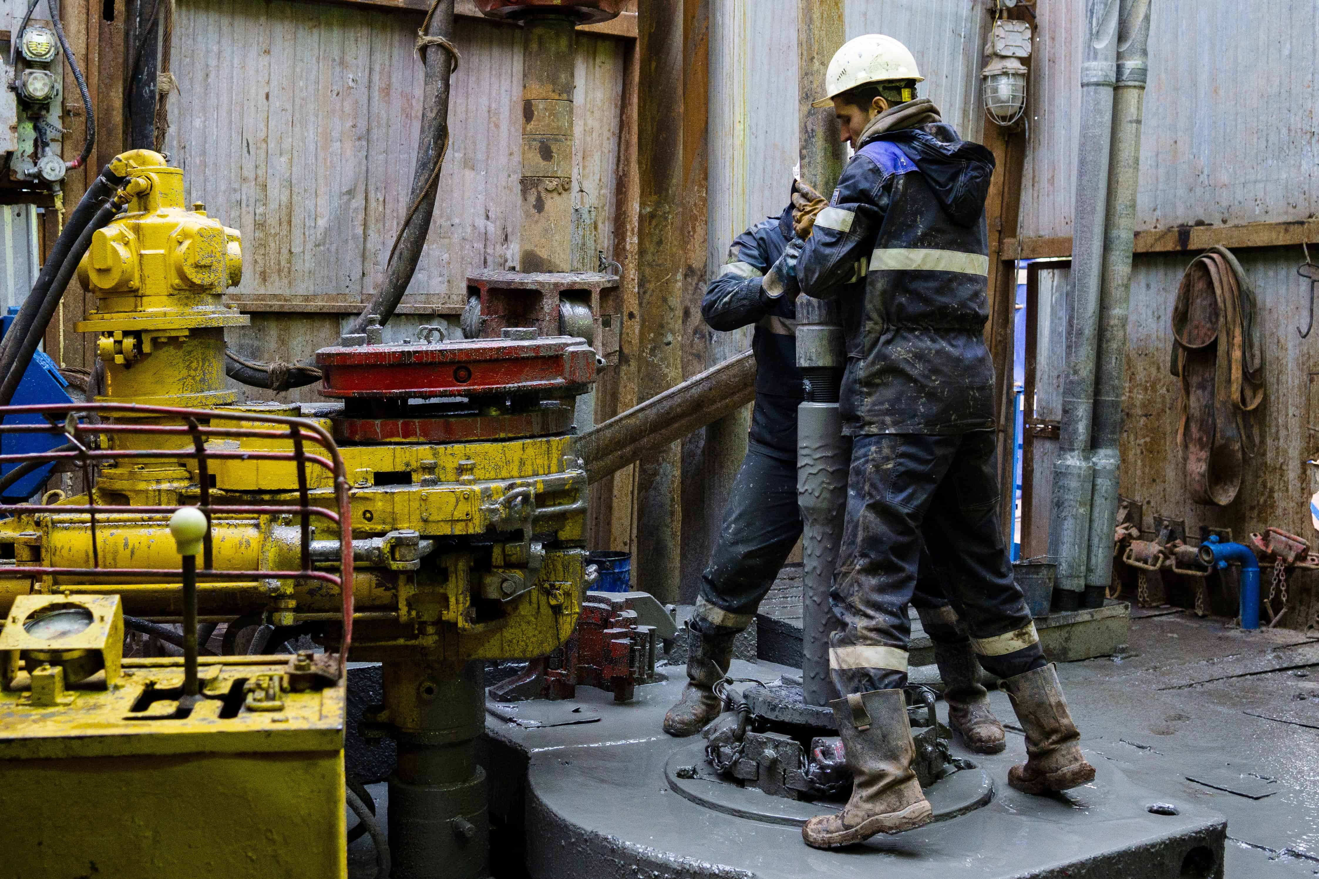 Roughnecks on the drill floor running pipe demonstrating resilience during their long shift