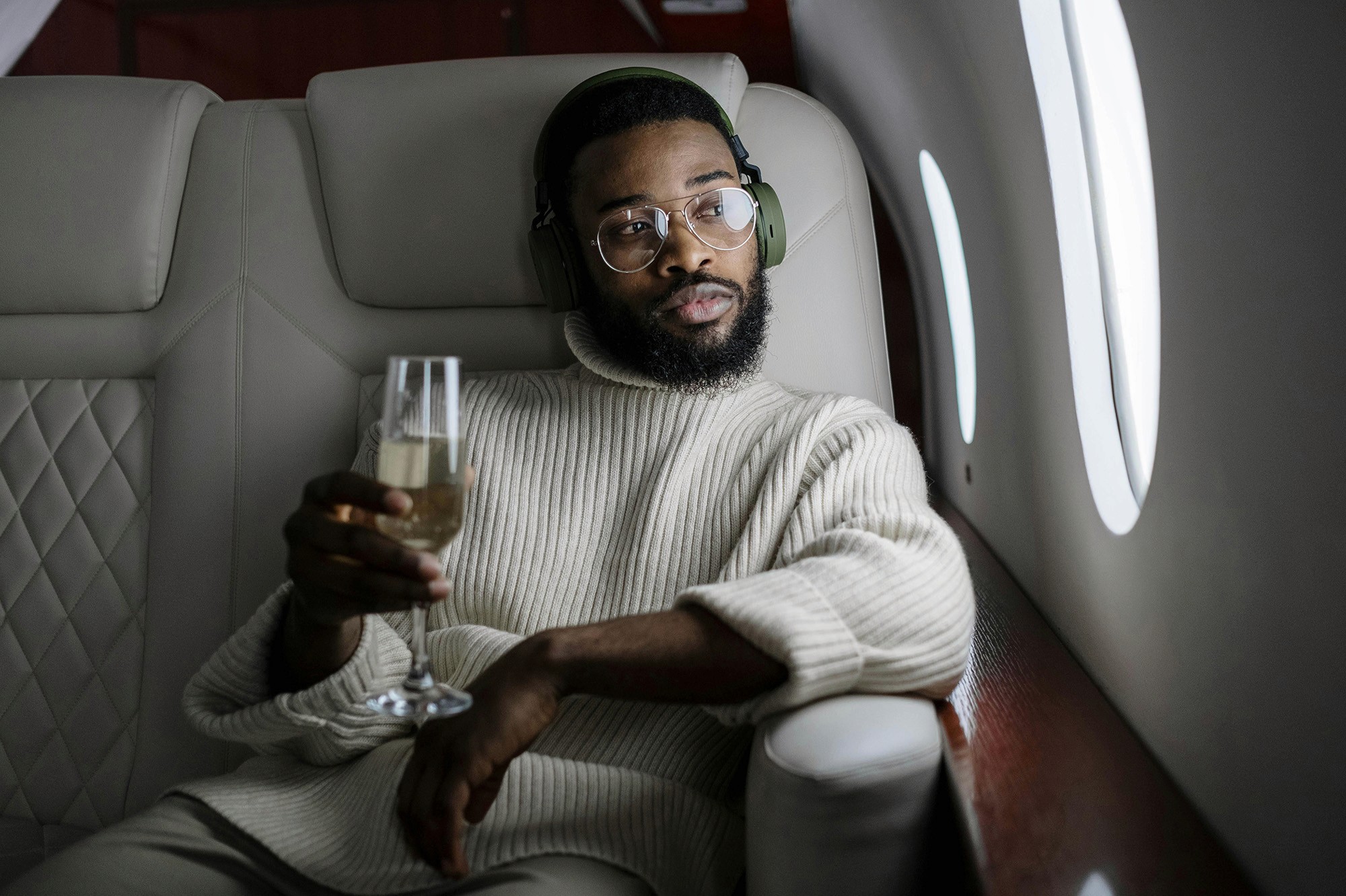 Man wearing headphones inside an airplane.