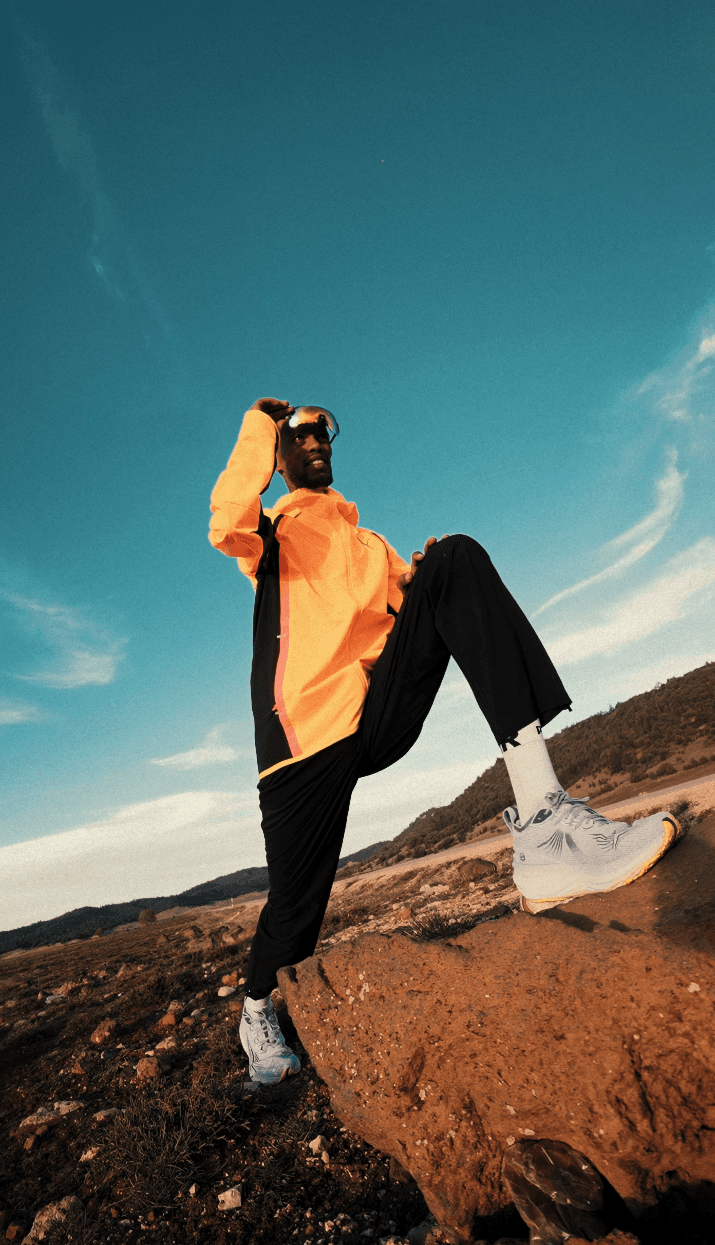 Bride in white dress walking on street, man in background