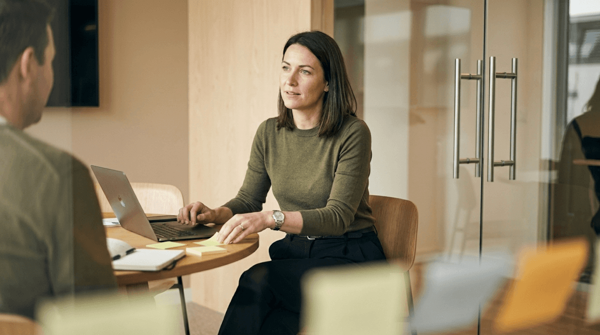 Two colleagues reviewing financials together on a laptop