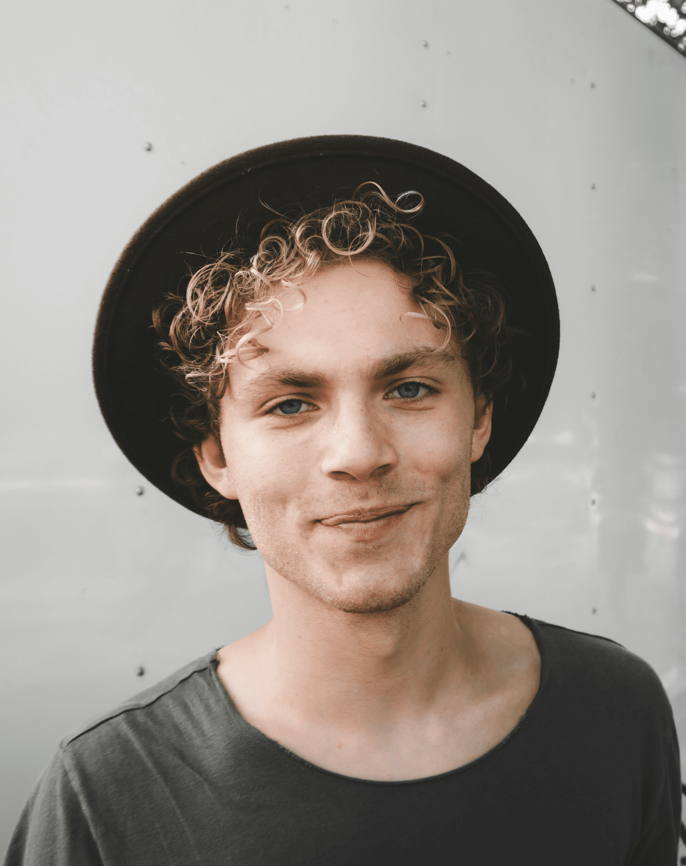 man standing near white wall