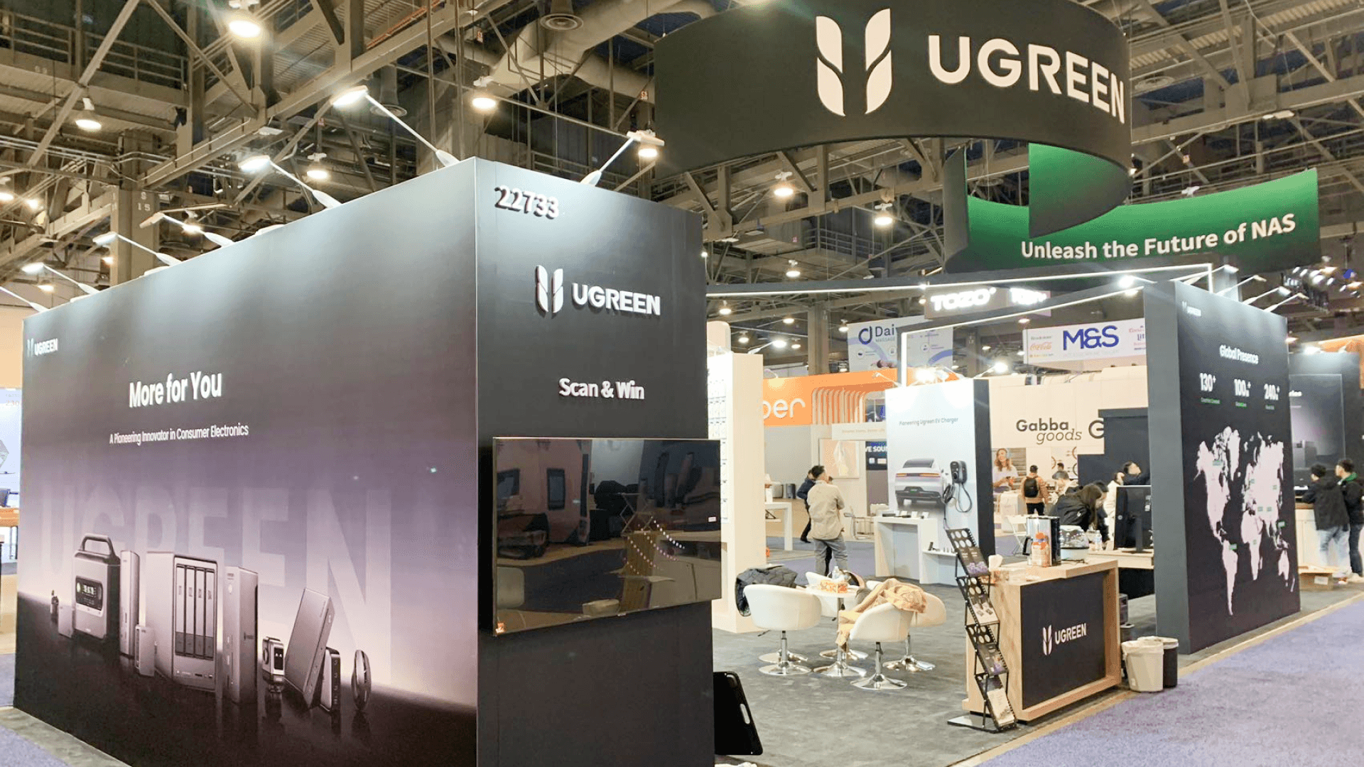 Ugreen CES 2024 large island booth at LVCC Las Vegas – power and data routing for charging demo counters with clean cable management