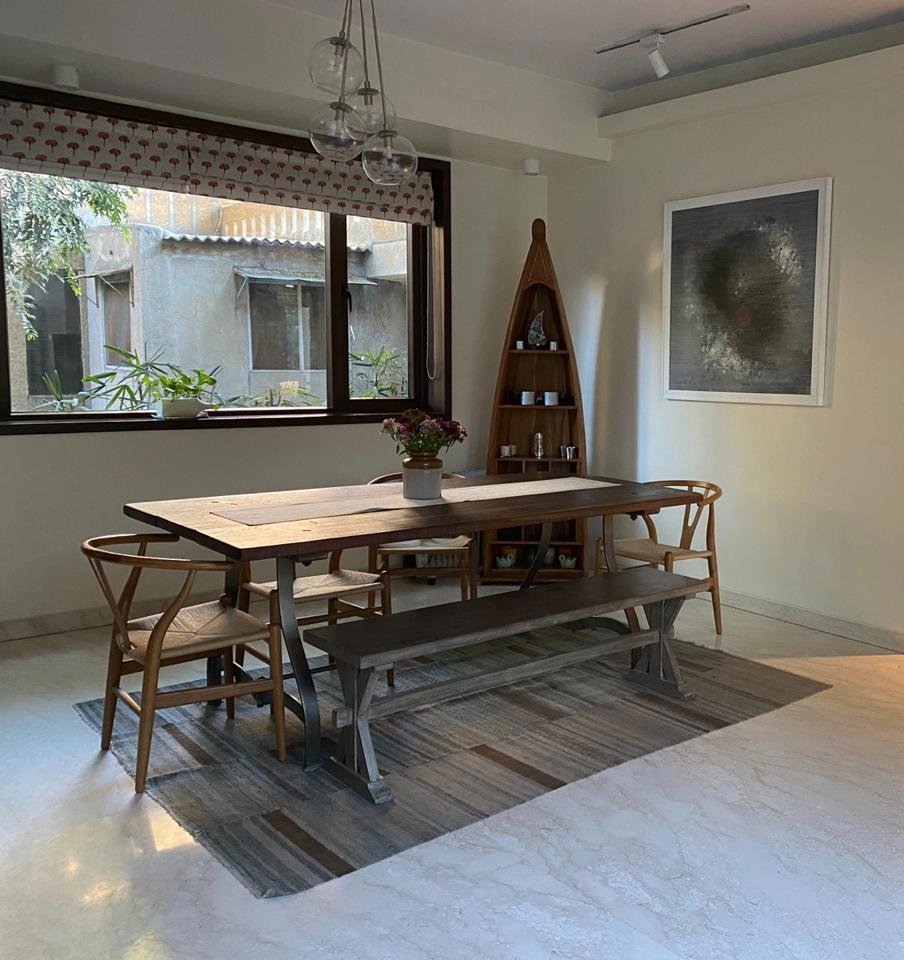 Nature-inspired preschool entrance with sculptural tree partitions and suspended green leaf ceiling panels.