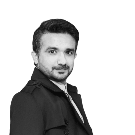 man wearing black crew-neck shirt and black cap in front of glass wall