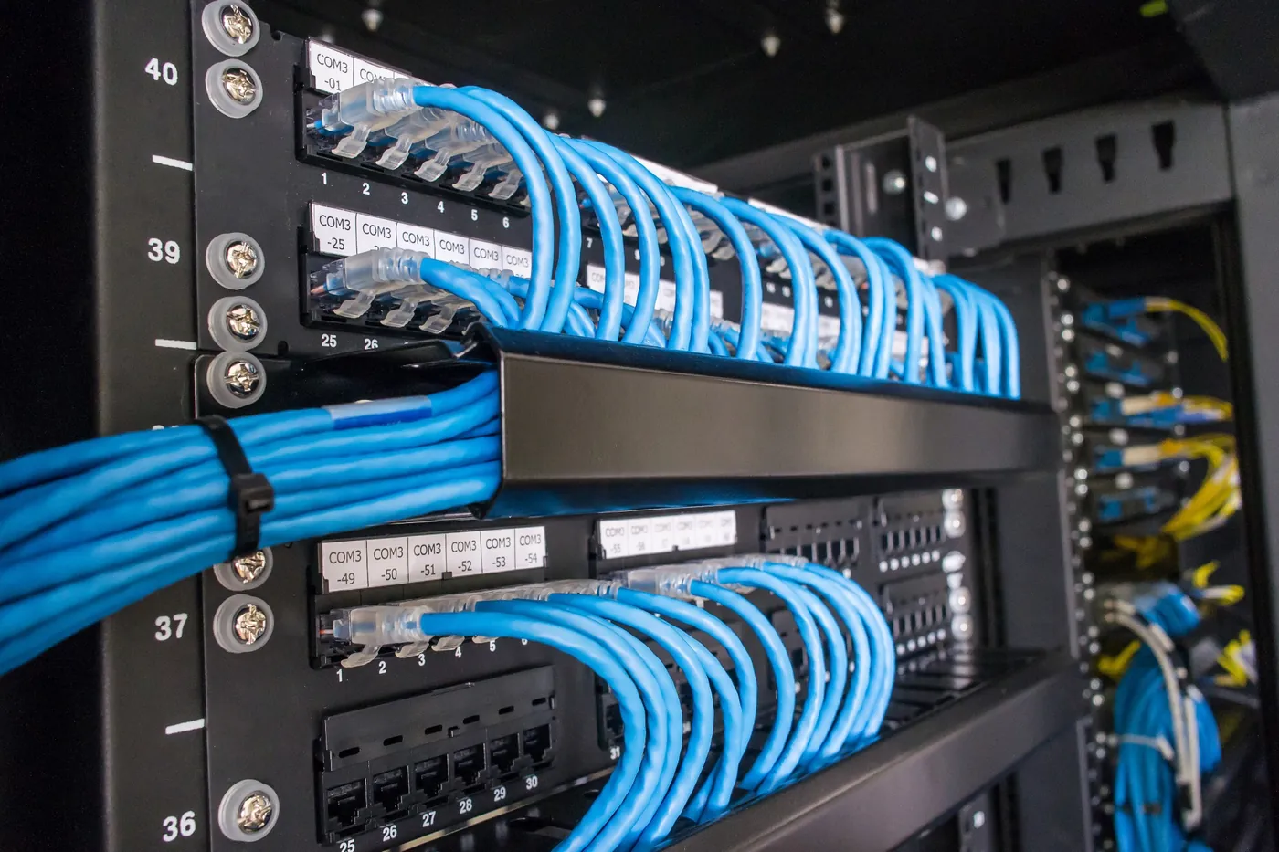 Structured network cabling with labeled patch panels and clean cable management in server rack.