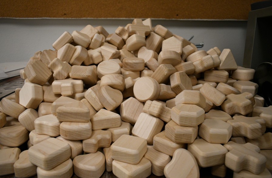 A pile of unfinished wooden toy shapes in the Doodle Pirates workshop
