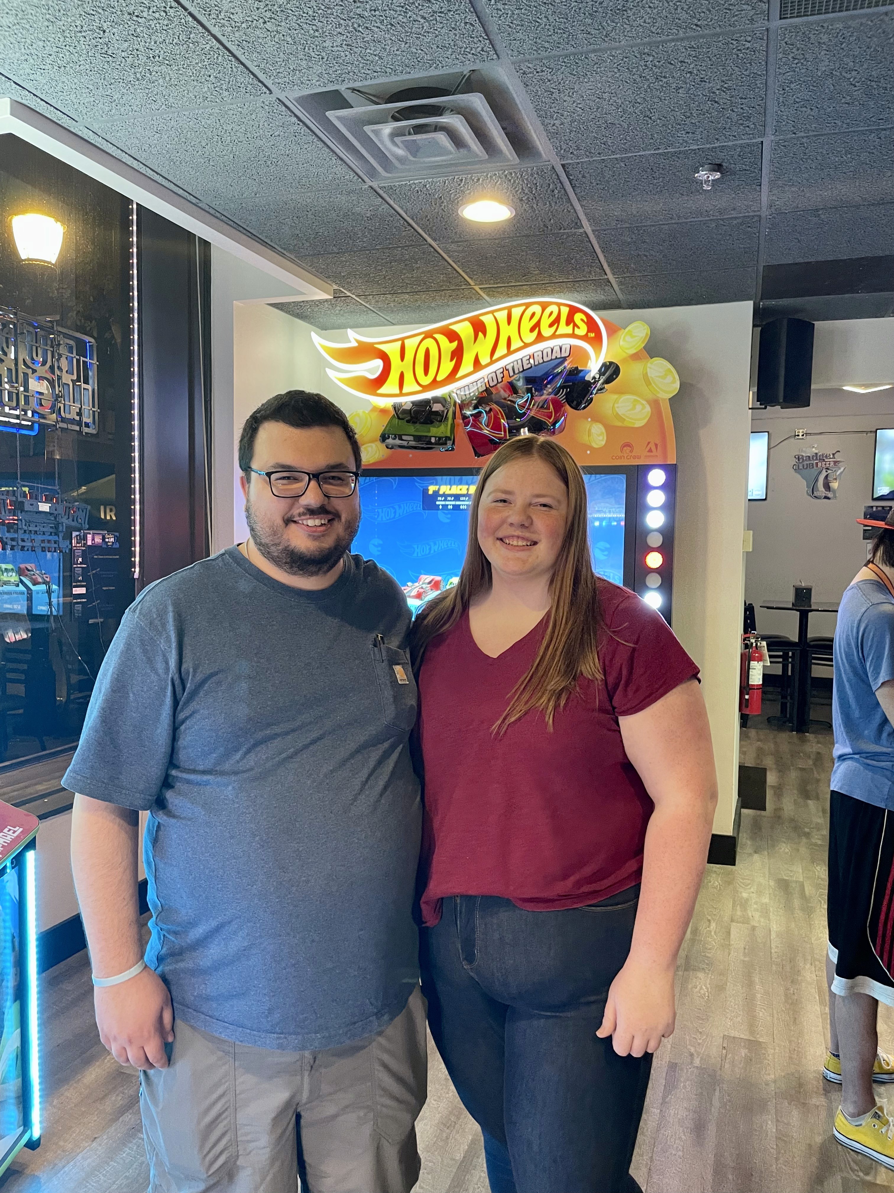woman holding a phone and man looking at the phone. both are smiling