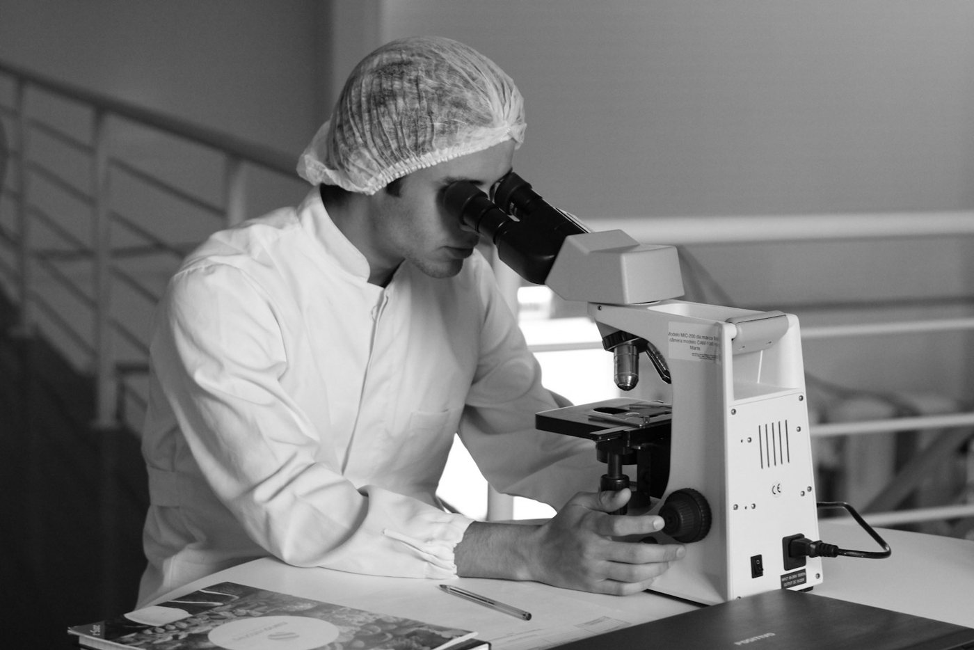 A scientist looking into a microscope in a laboratory