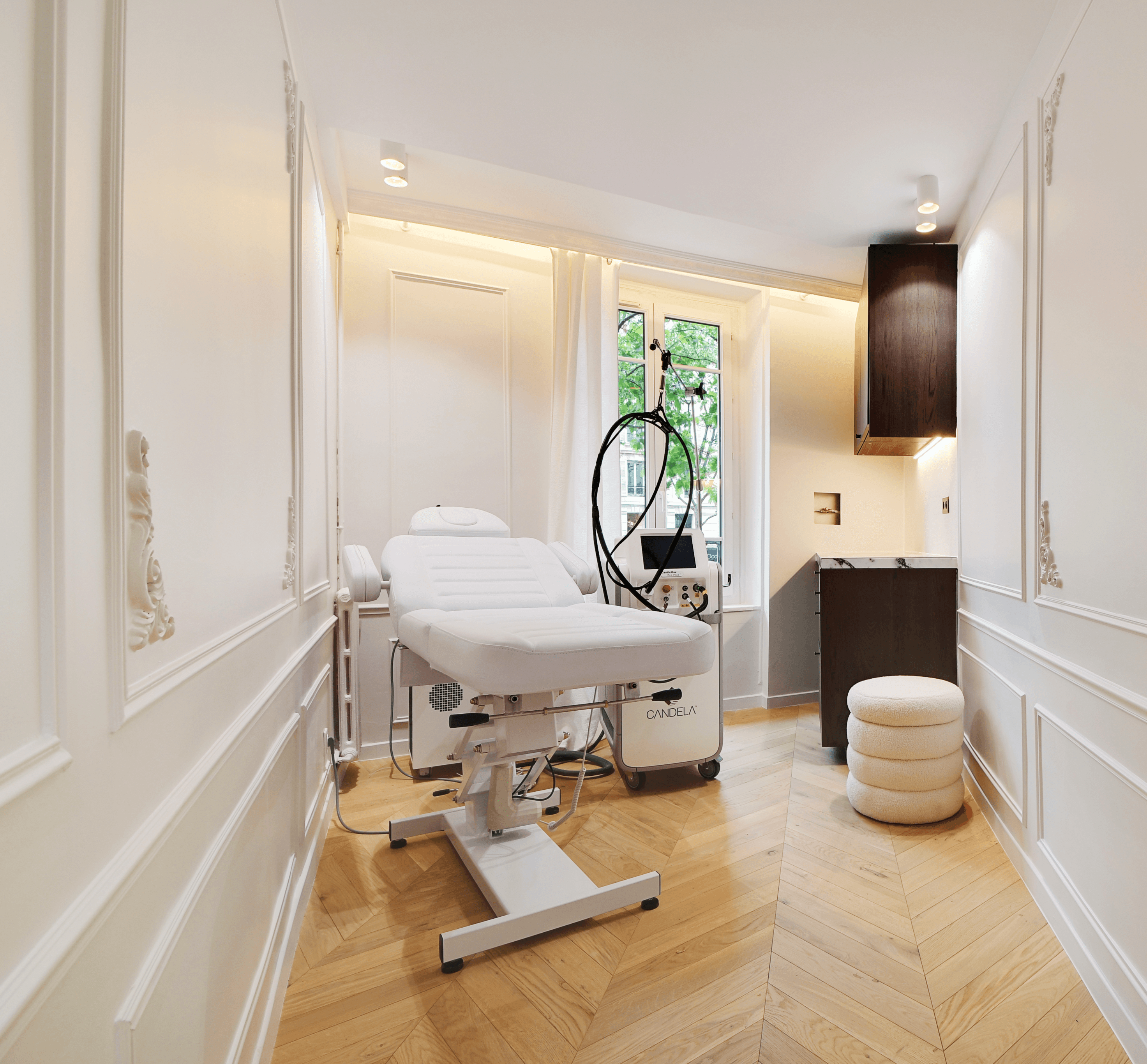 Close-up of hands holding a small glass bottle with a liquid skincare product, against a soft, blurred background